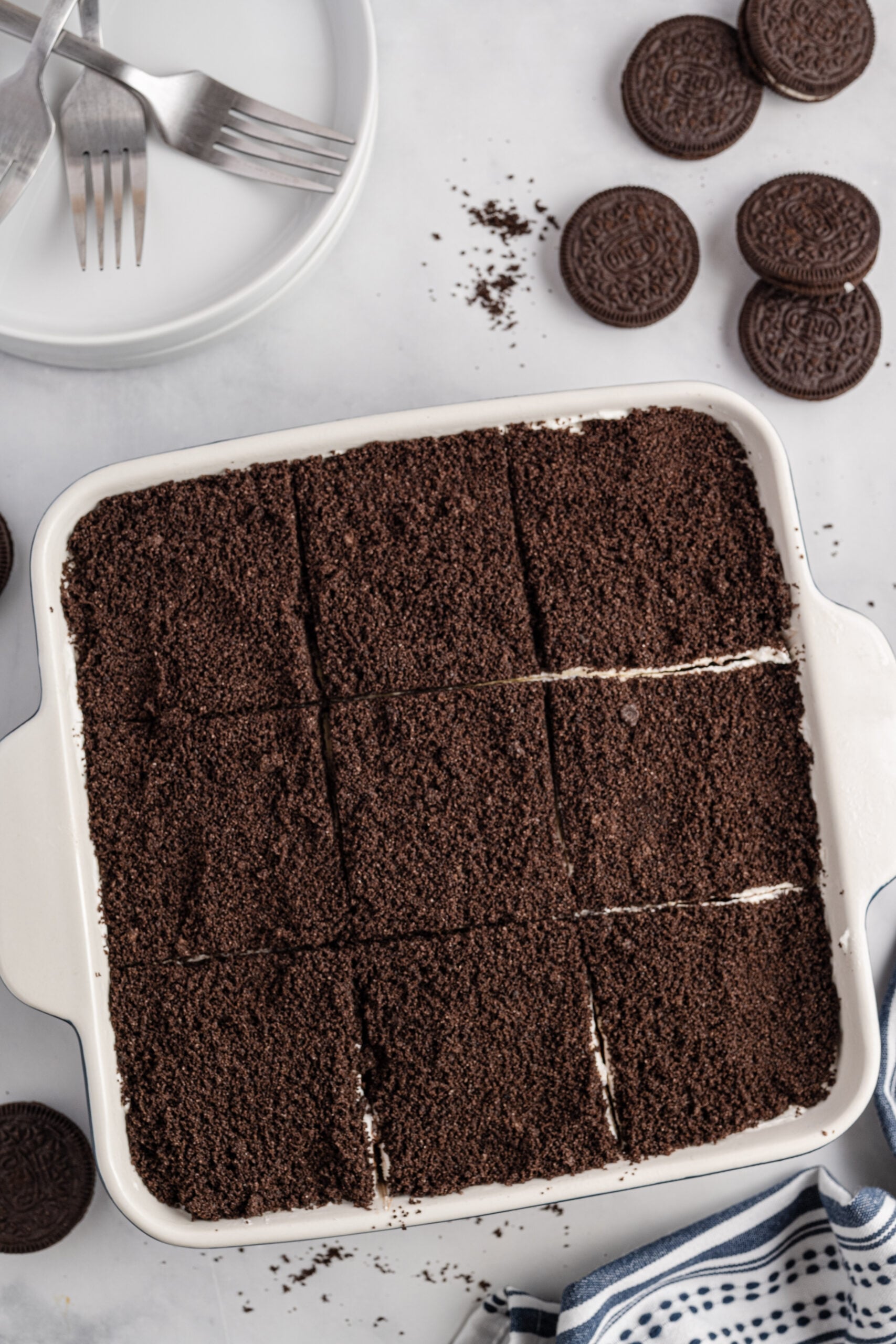 Overhead view of Oreo Delight in a baking dish cut into nine slices.