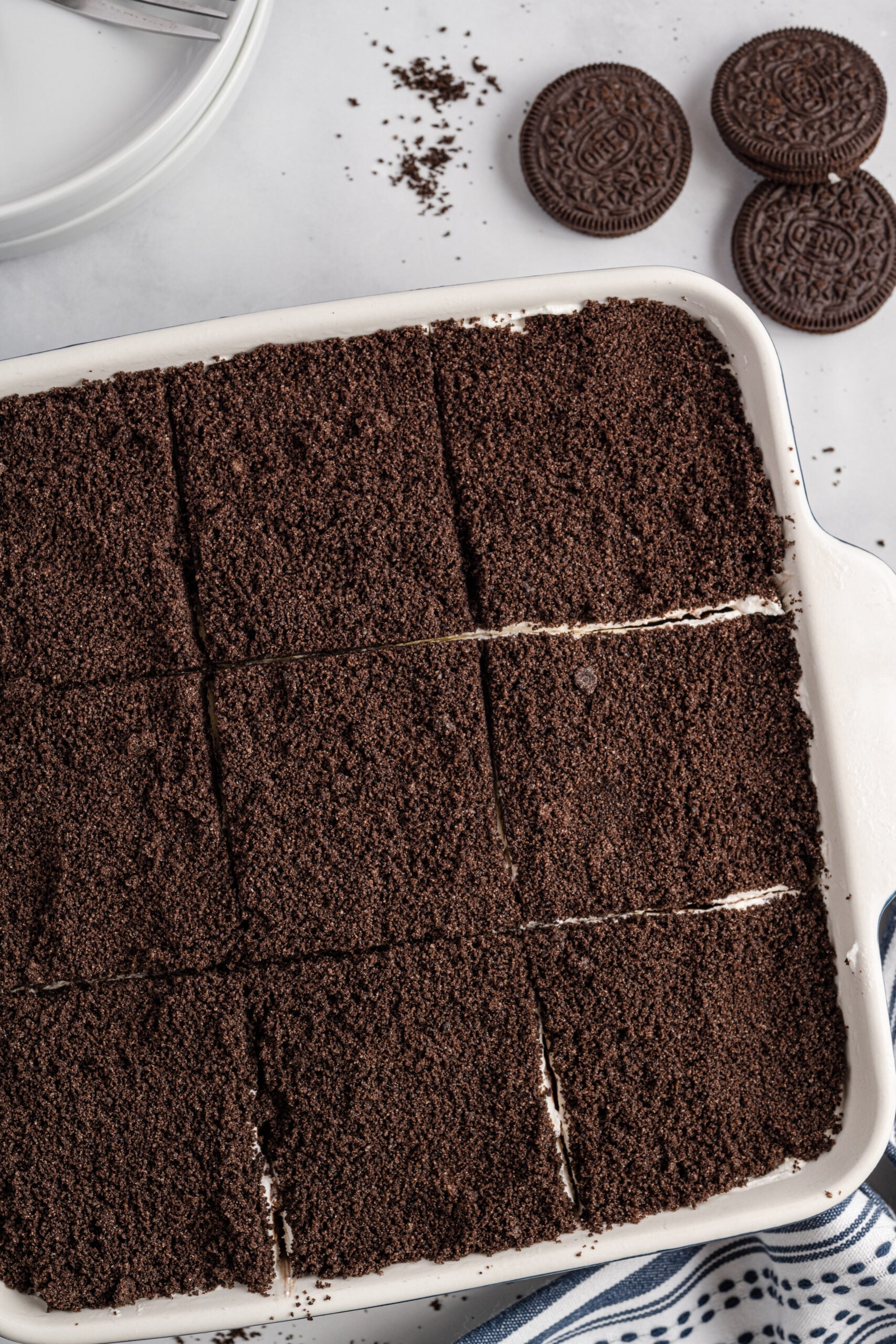 Overhead view of Oreo Delight in a baking dish cut into nine slices.