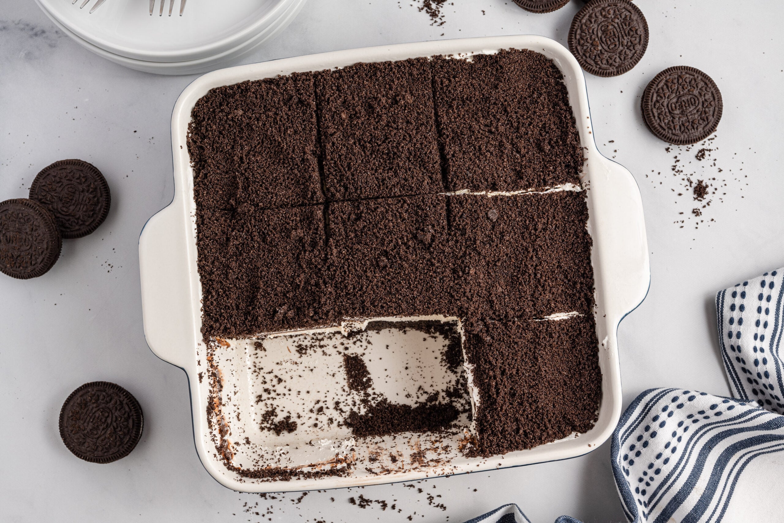 Overhead view of Oreo Delight in a baking dish cut into slices with two removed.
