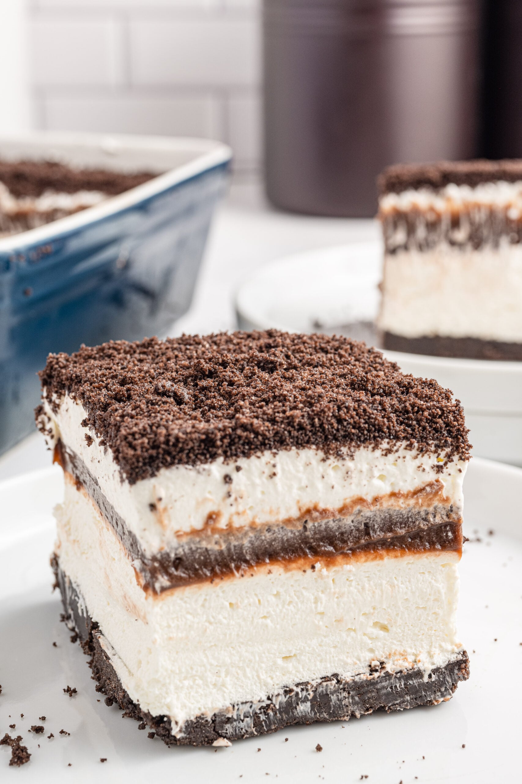 Front view of a slice of Oreo Delight on a white plate.