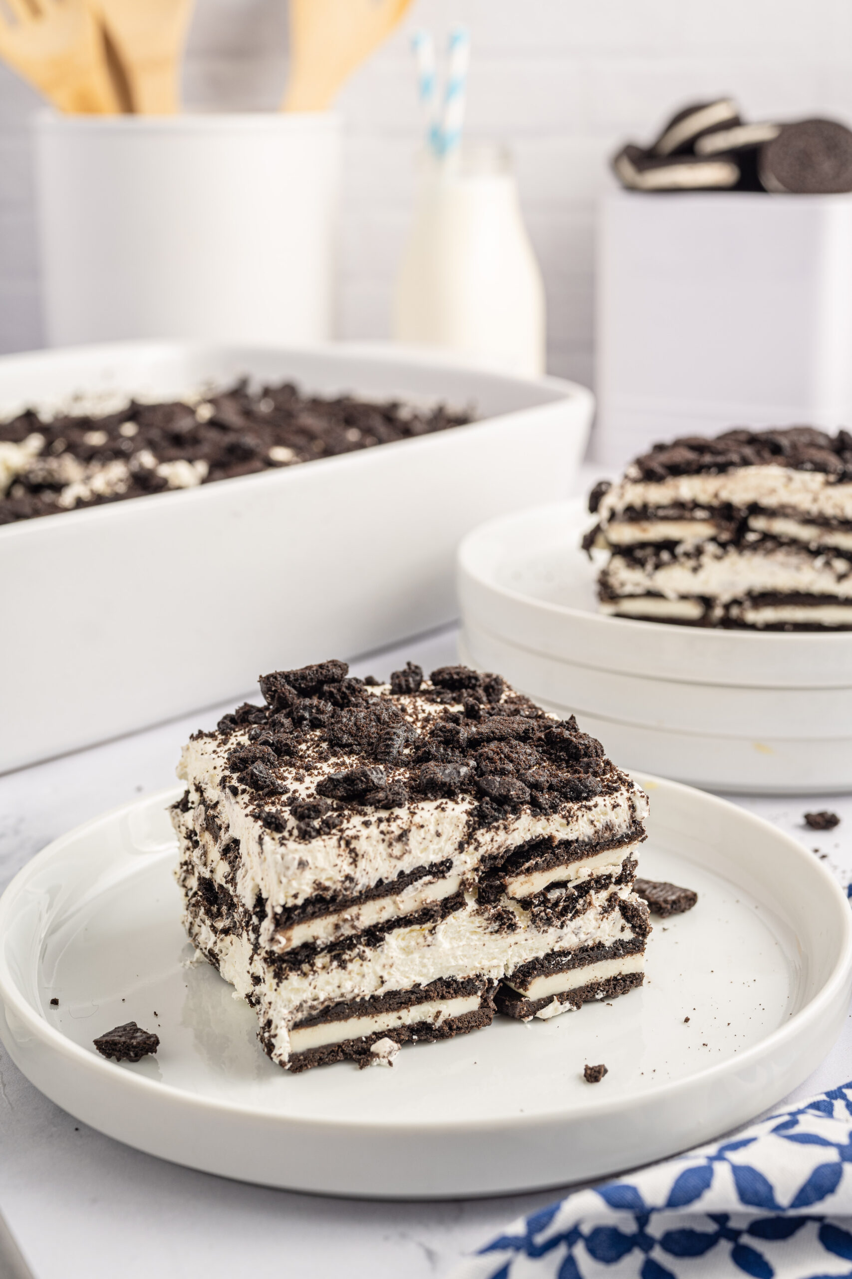 Front view of a slice of Oreo Icebox Cake on a white plate.