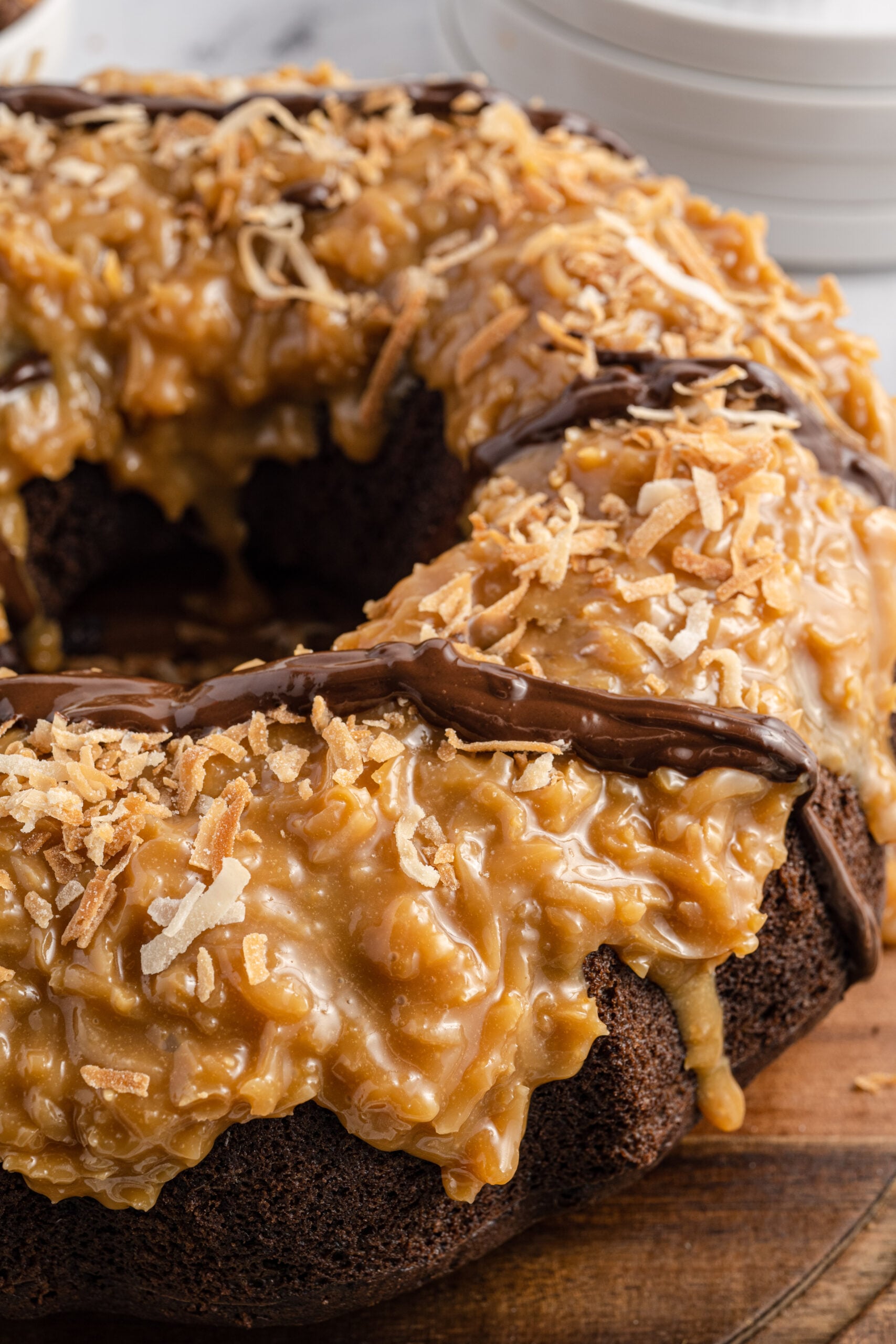 Close up view of Samoa Cake on a wooden cutting board.