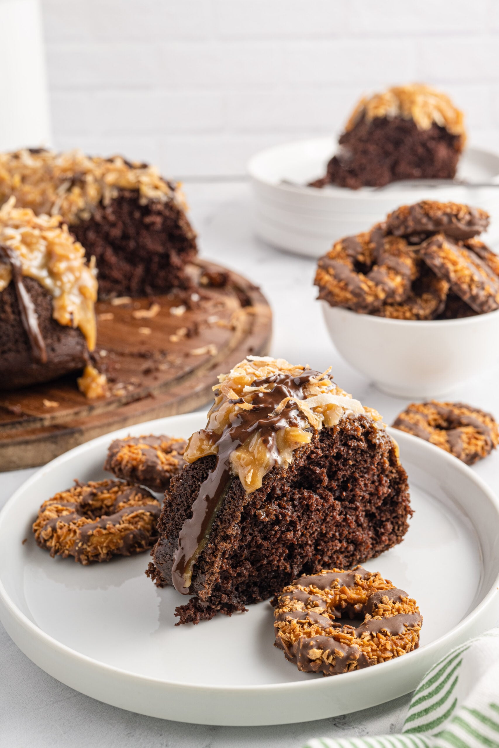Front view of a slice of Samoa Cake on a white plate.