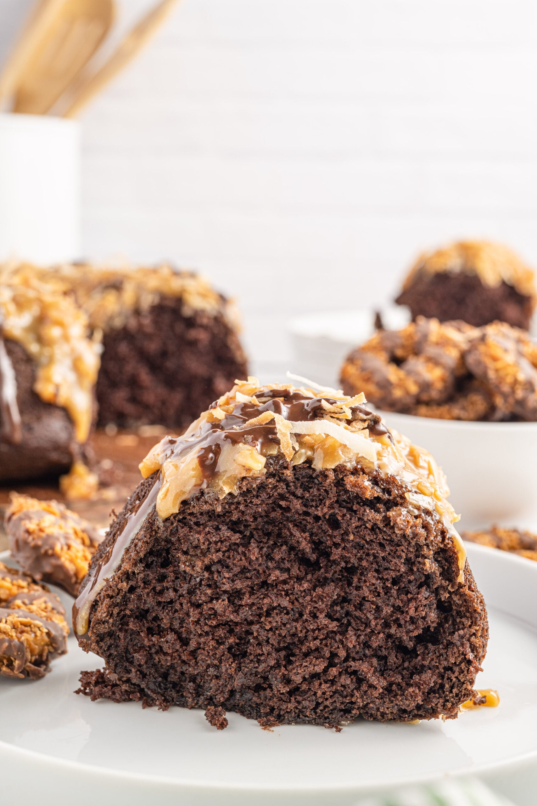 Side view of a slice of Samoa Cake on a white plate.