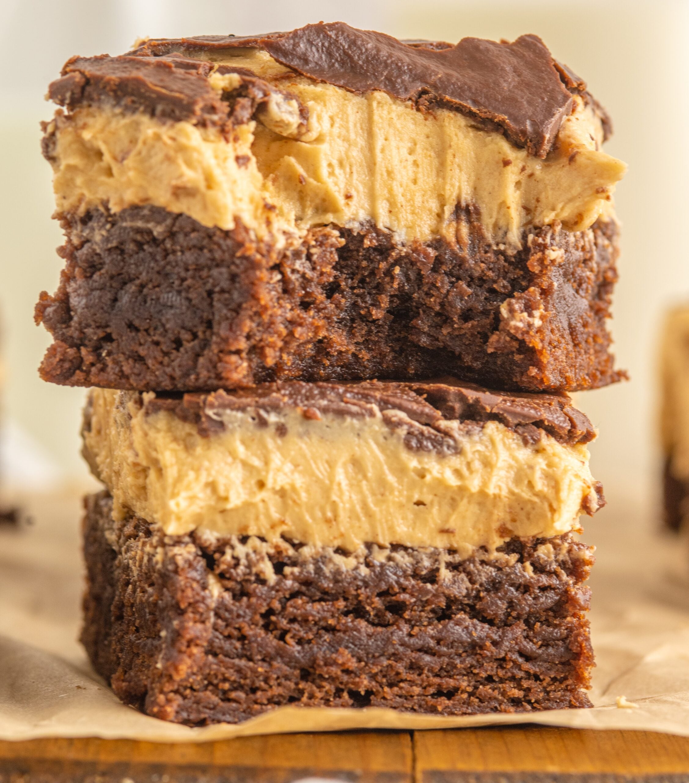 up close shot of two Buckeye Brownies stacked on top of each other with a bite removed from the top one. 