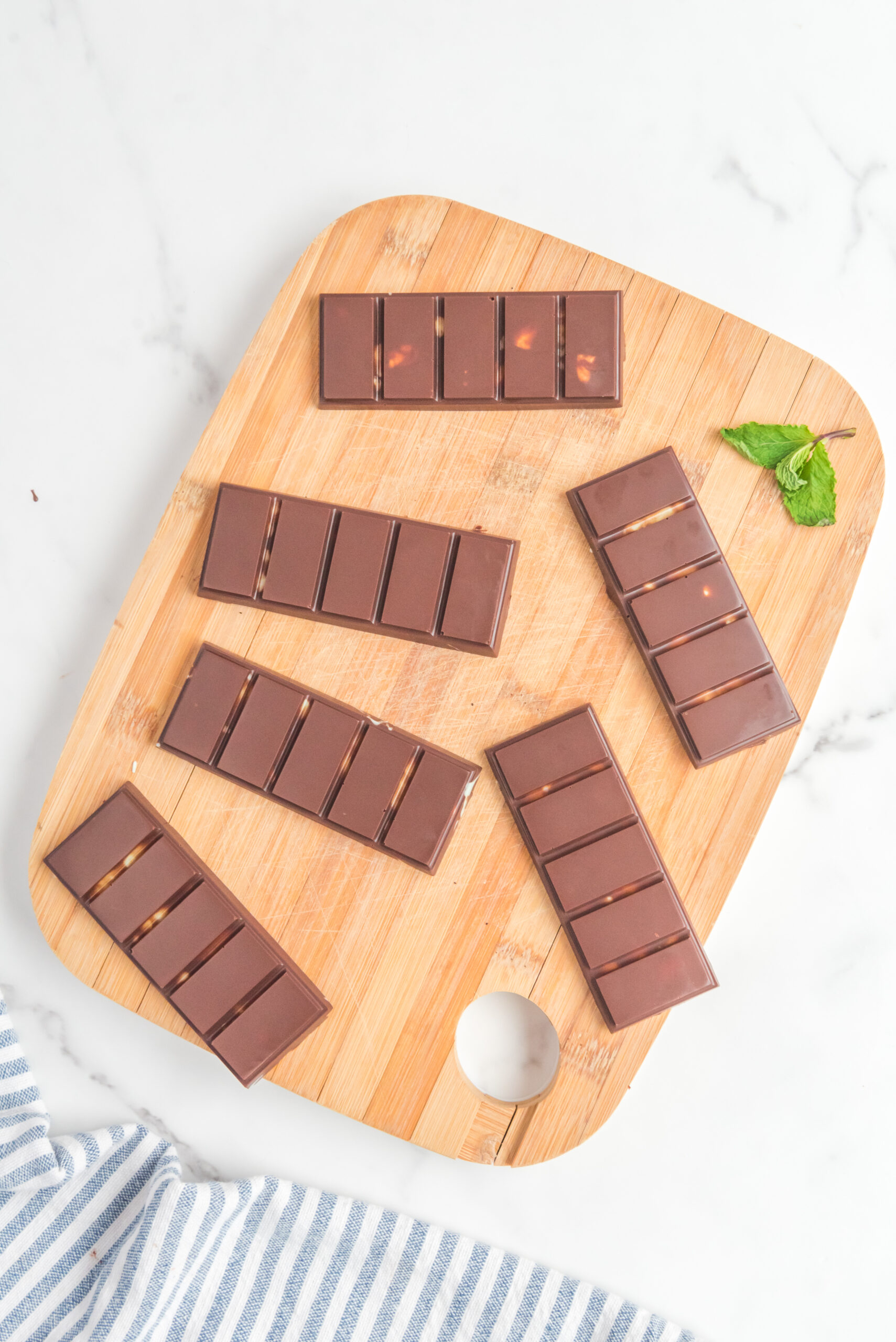 Overhead view of Homemade Andes Mints on a wooden cutting board.