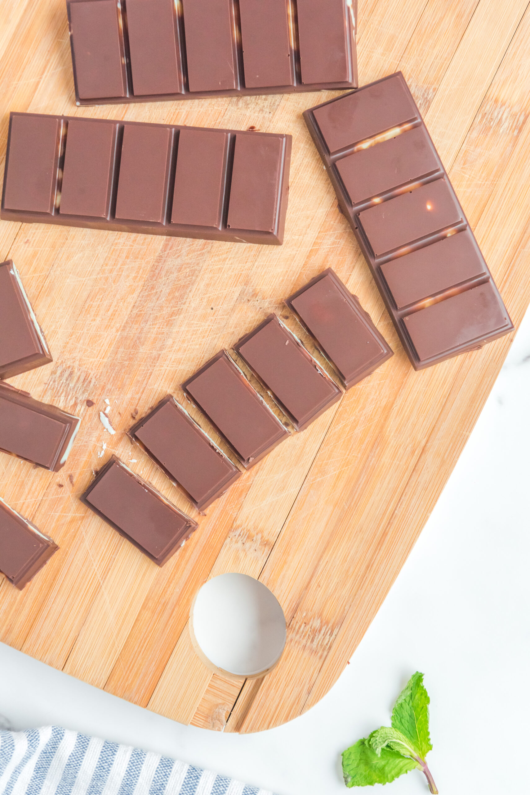 Overhead view of Homemade Andes Mints on a wooden cutting board.