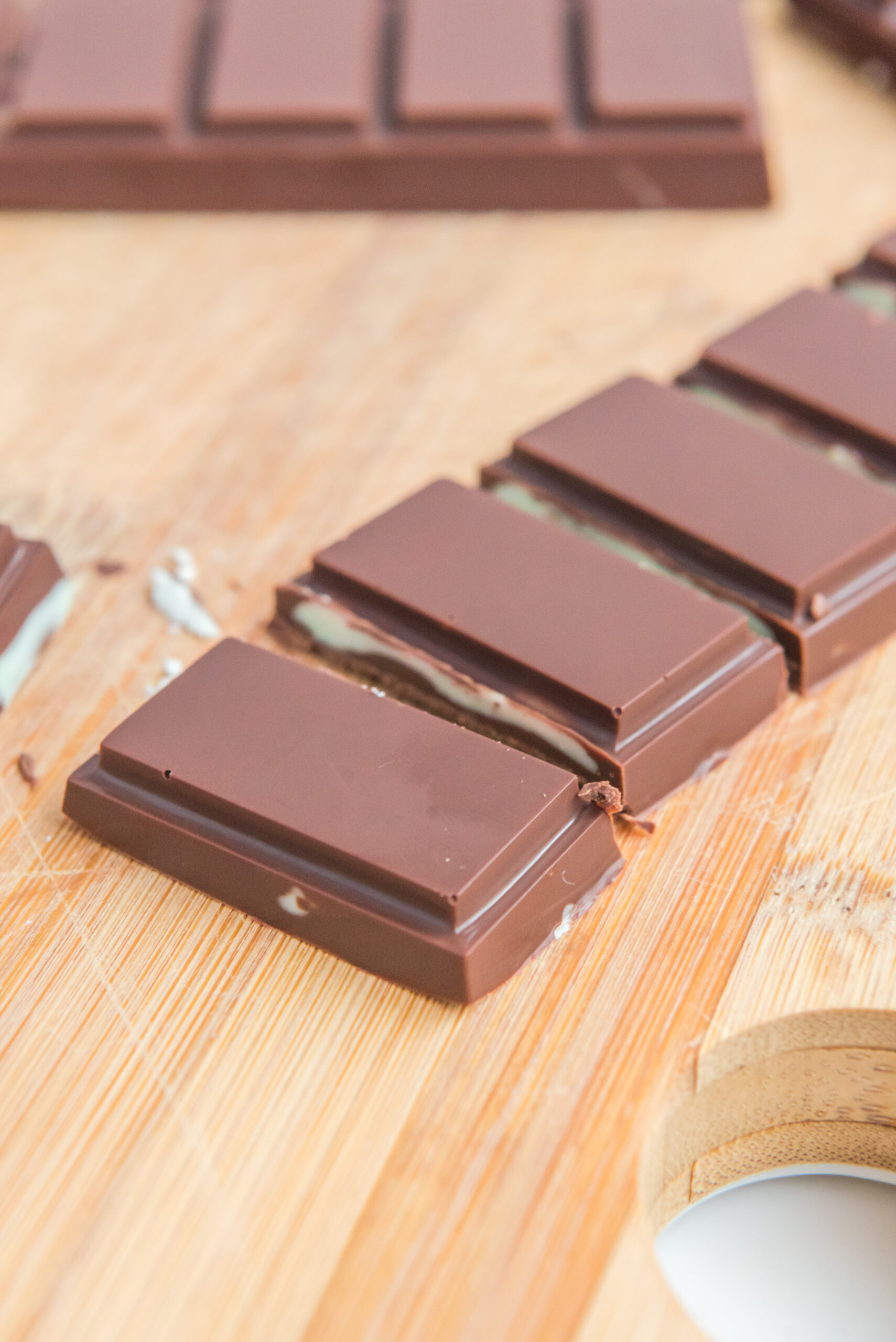 Front view of Homemade Andes Mints on a wooden cutting board.