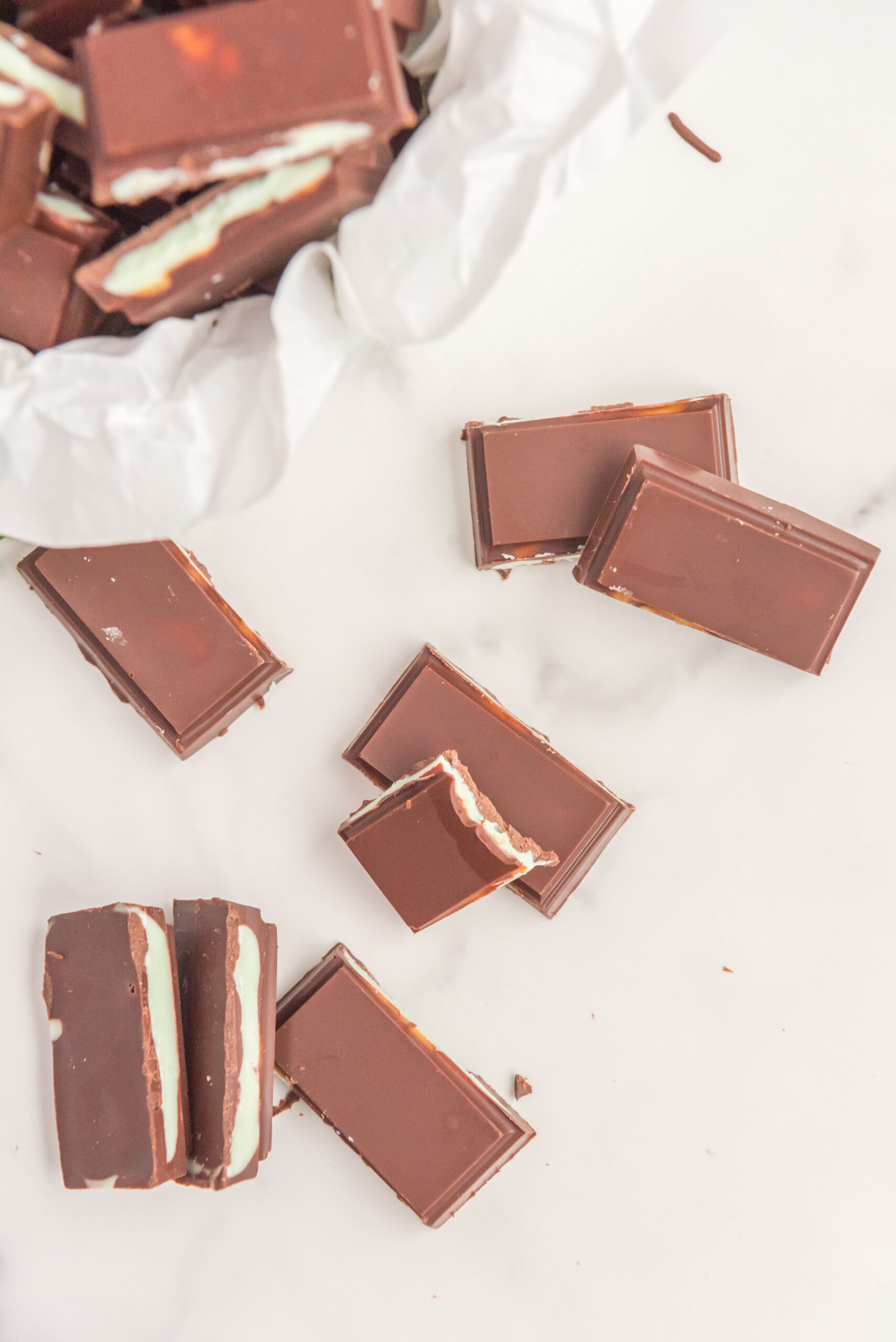 Overhead view of Homemade Andes Mints stacked with a bite removed from one mint.