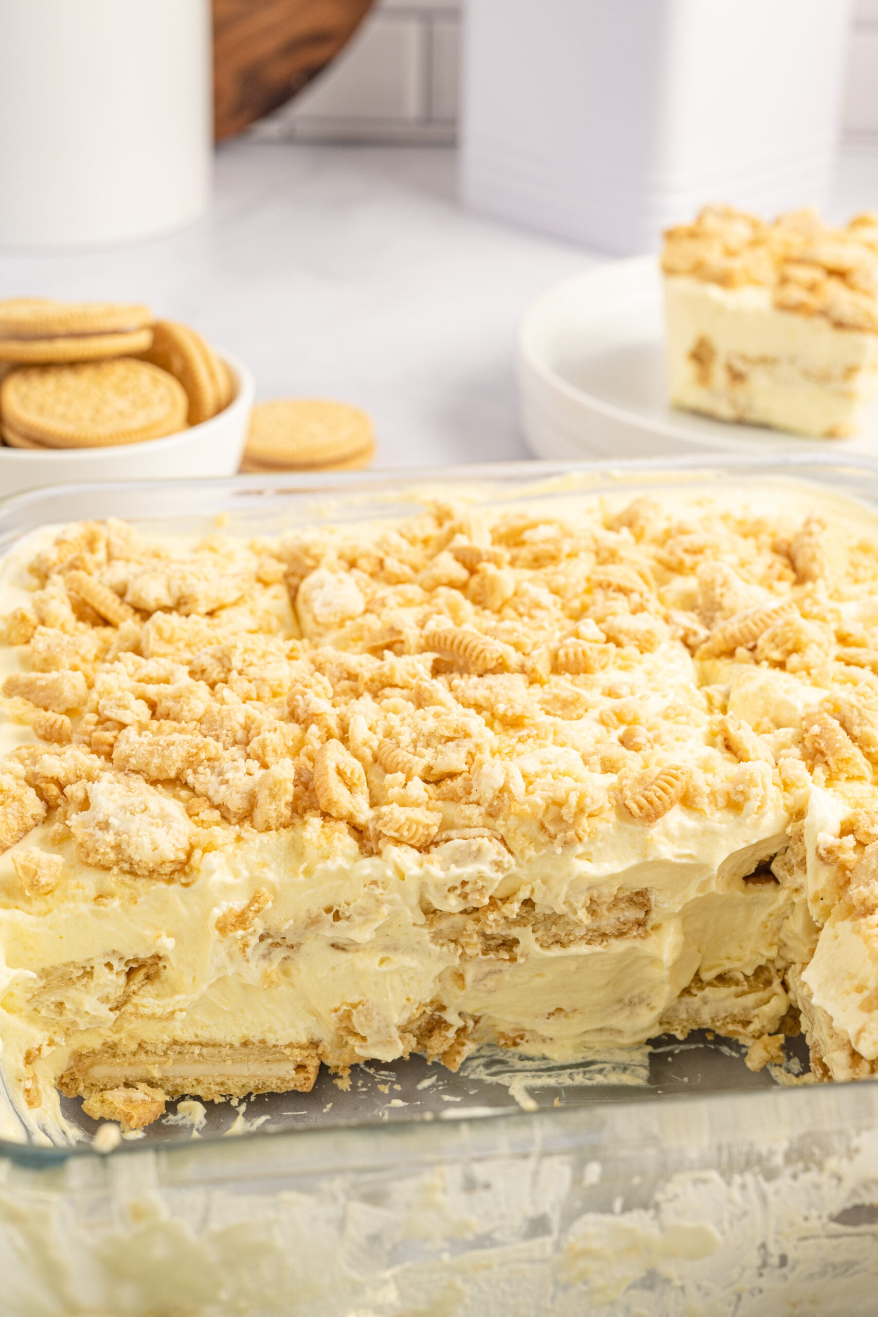 Close up view of Golden Oreo Icebox Cake in a clear baking dish with two slices removed.