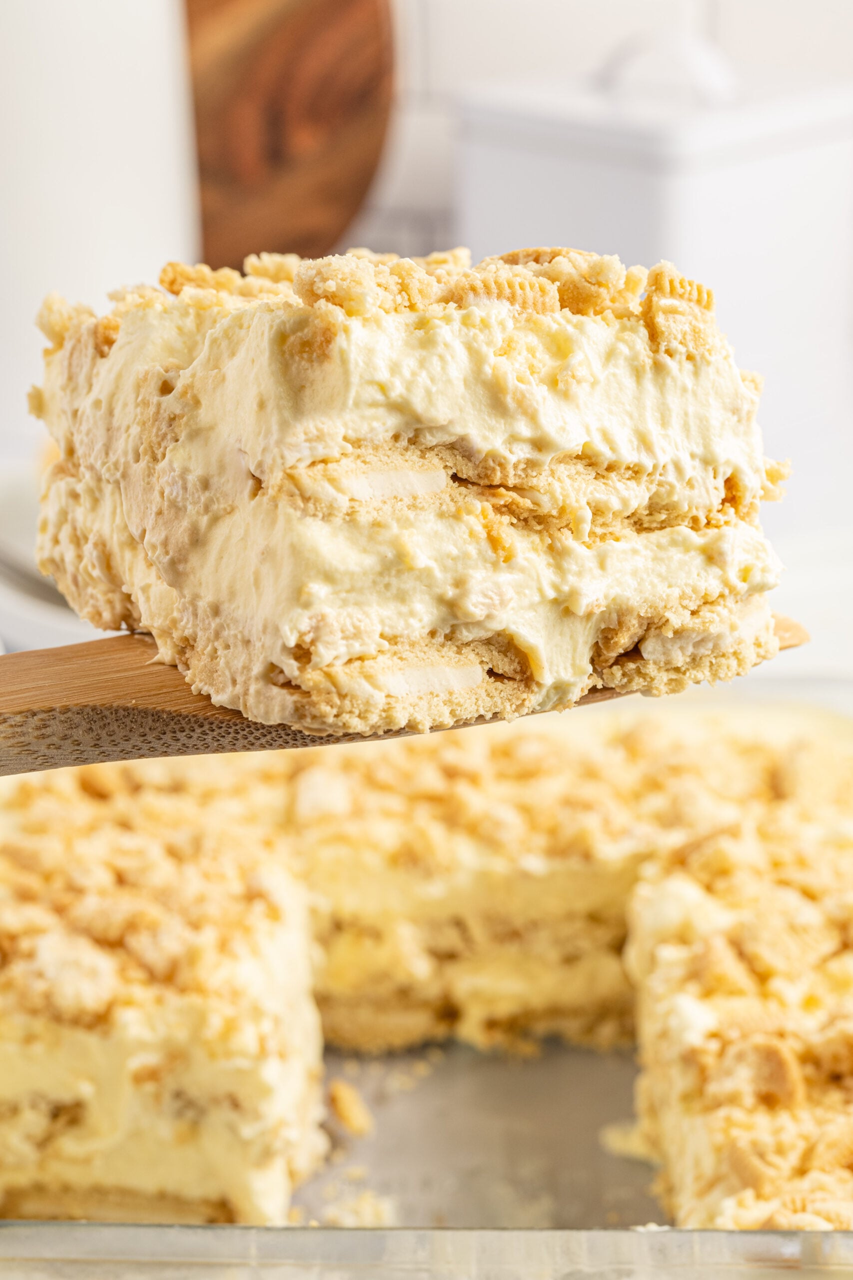 Front view of a slice of Golden Oreo Icebox Cake on a wooden spatula.
