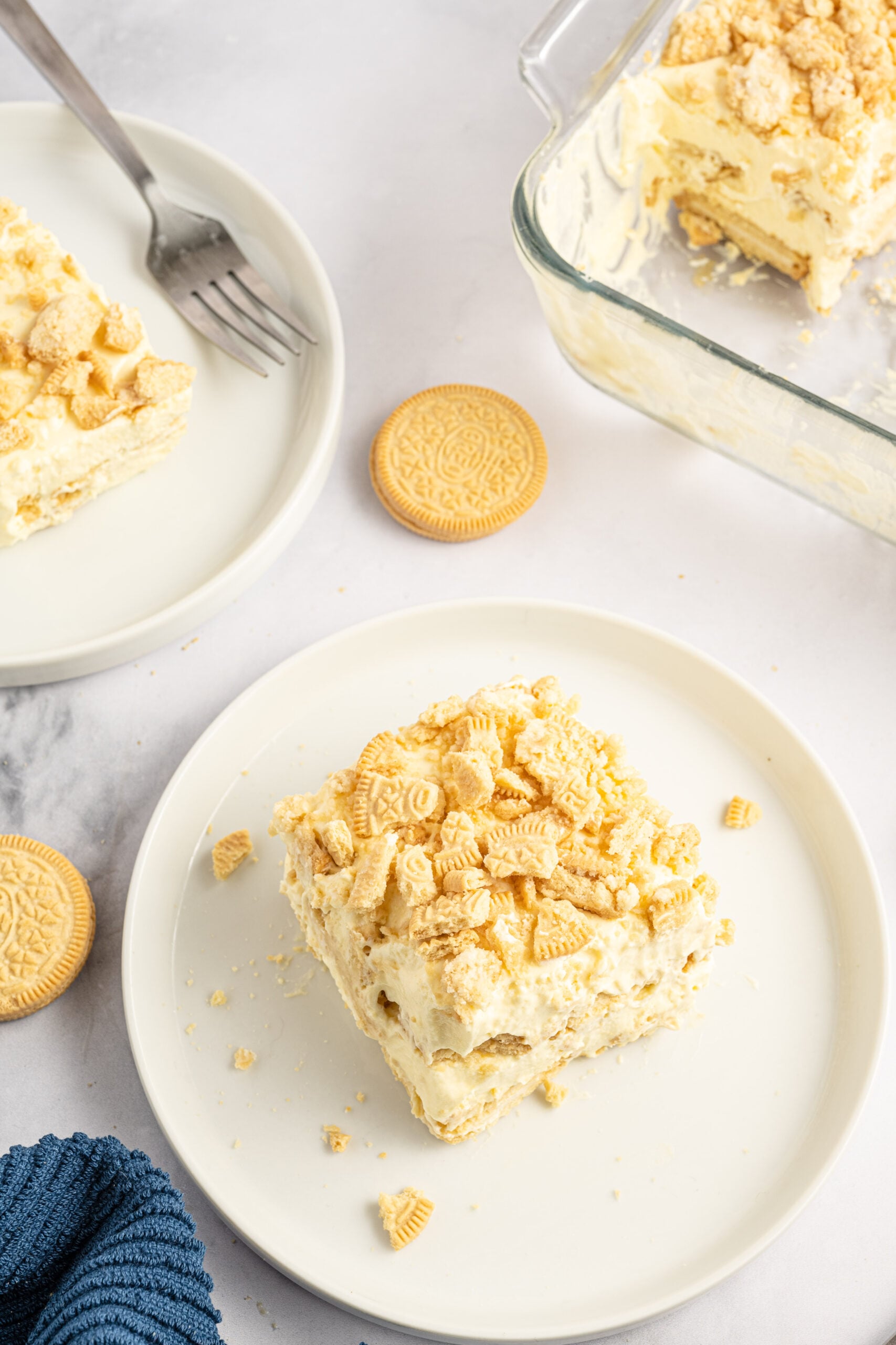 Overhead view of a slice of Golden Oreo Icebox Cake on a white plate.