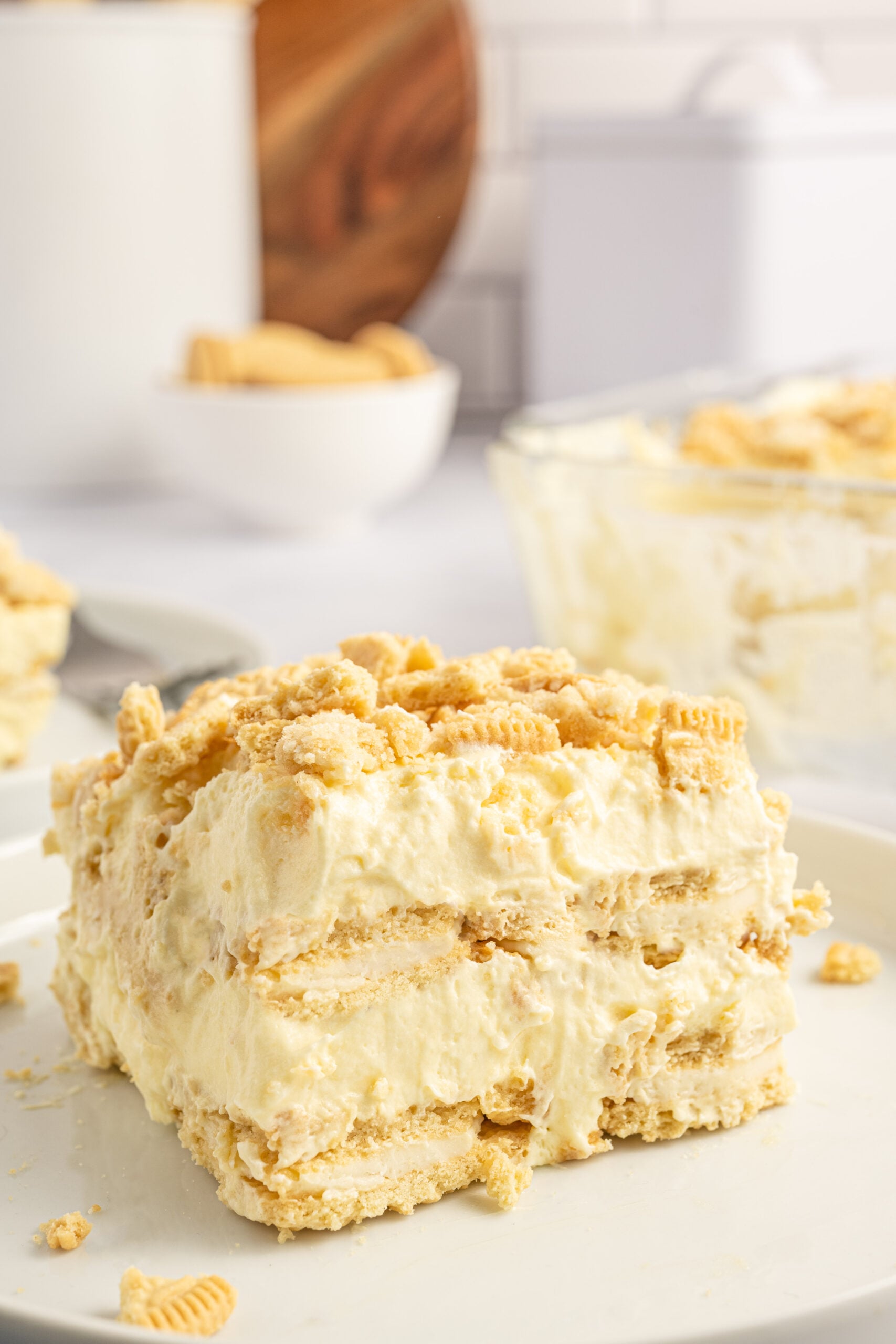 Front view of a slice of Golden Oreo Icebox Cake on a white plate.
