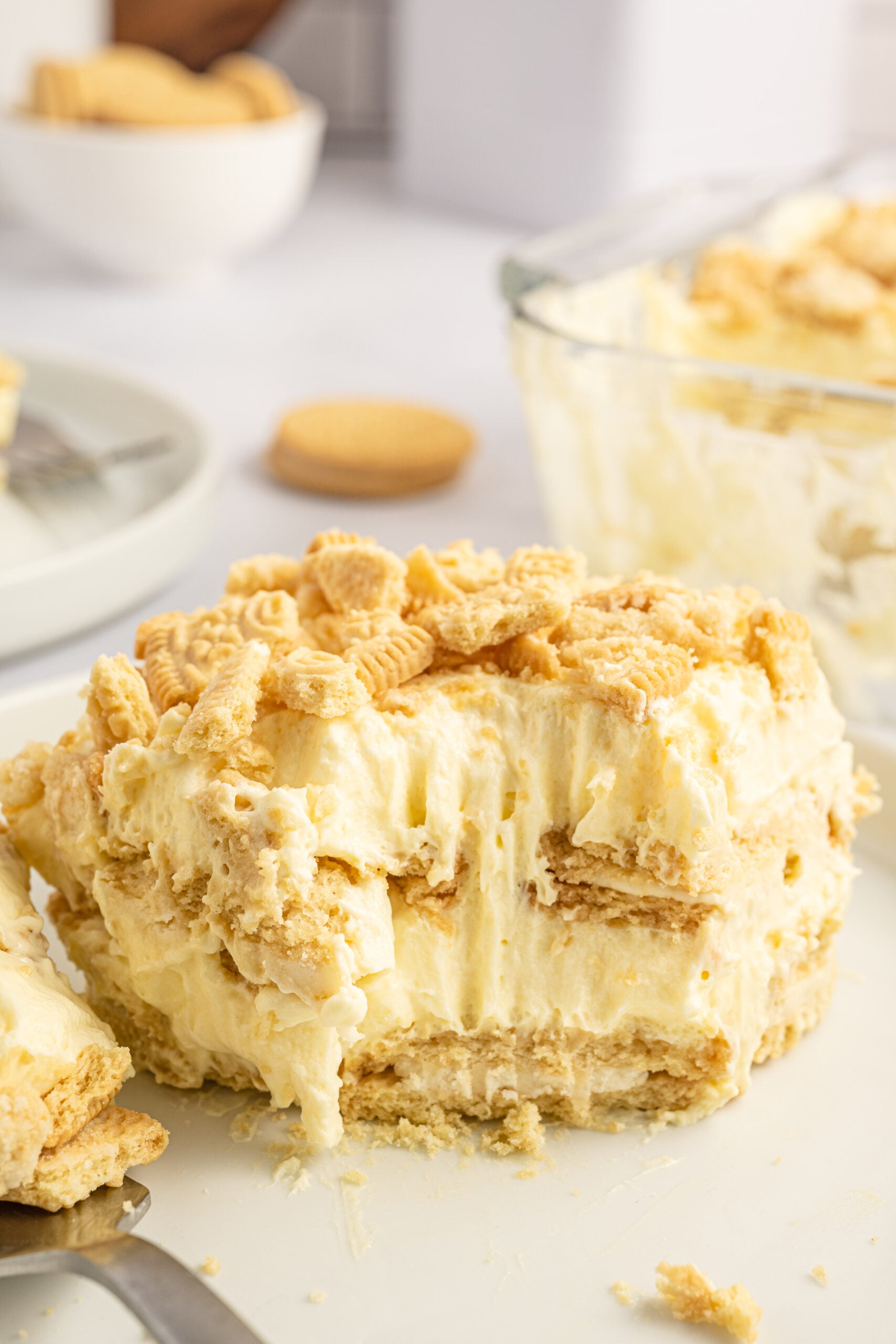 Front view of a slice of Golden Oreo Icebox Cake with a bite removed by a silver fork.