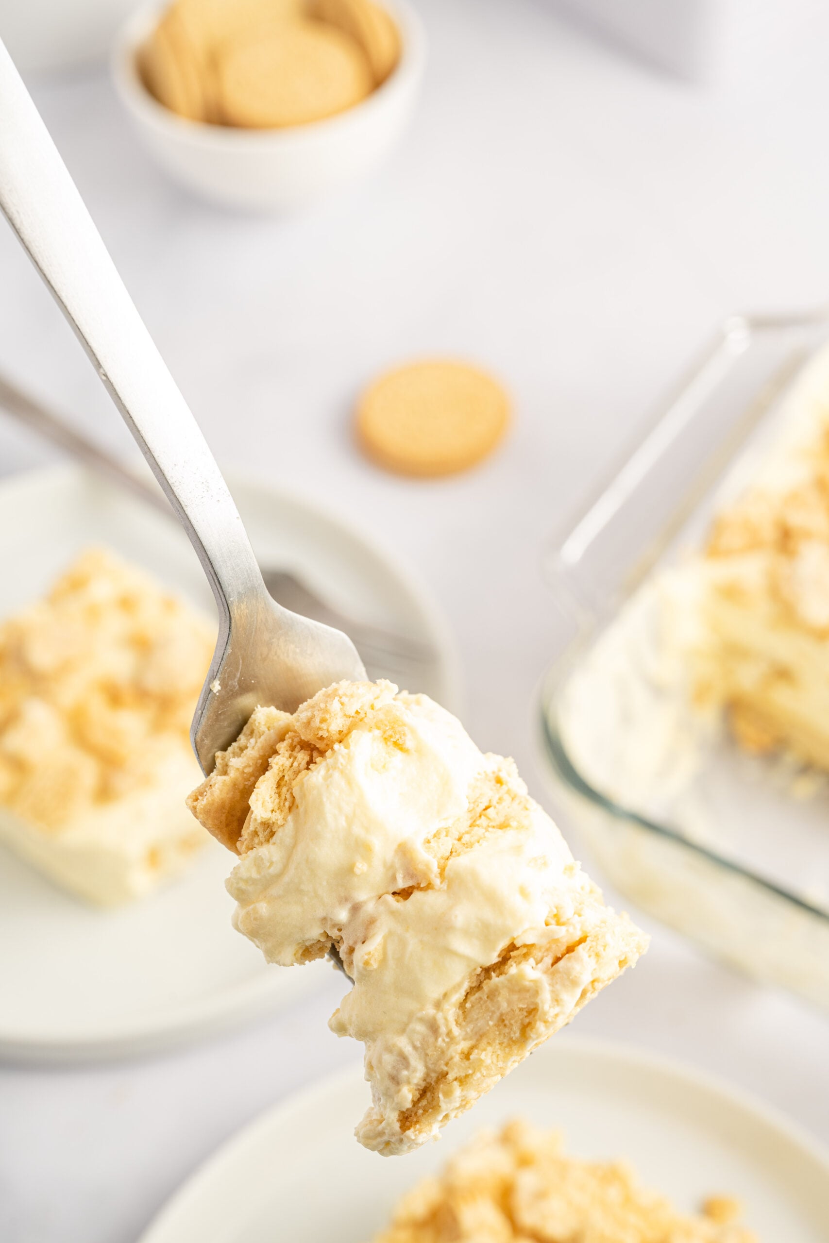 Close up view of a bite of Golden Oreo Icebox Cake on a silver fork.