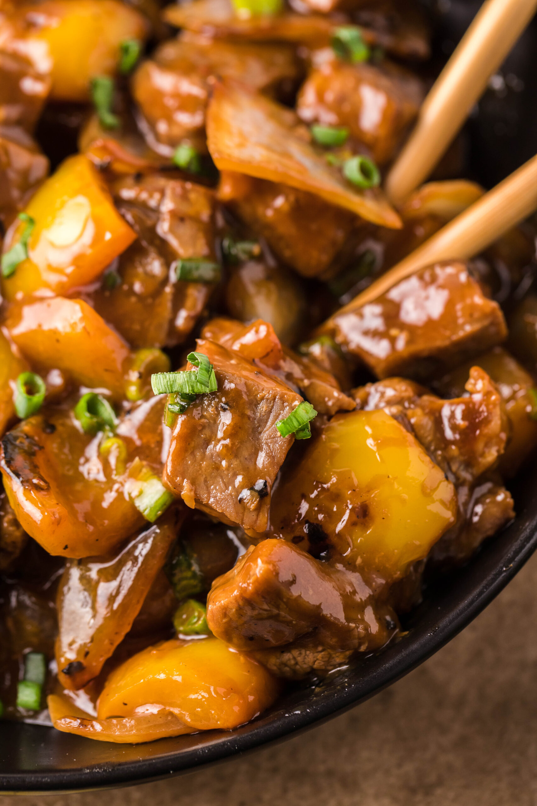 Close up view of Teriyaki Steak Bites in a black dish.