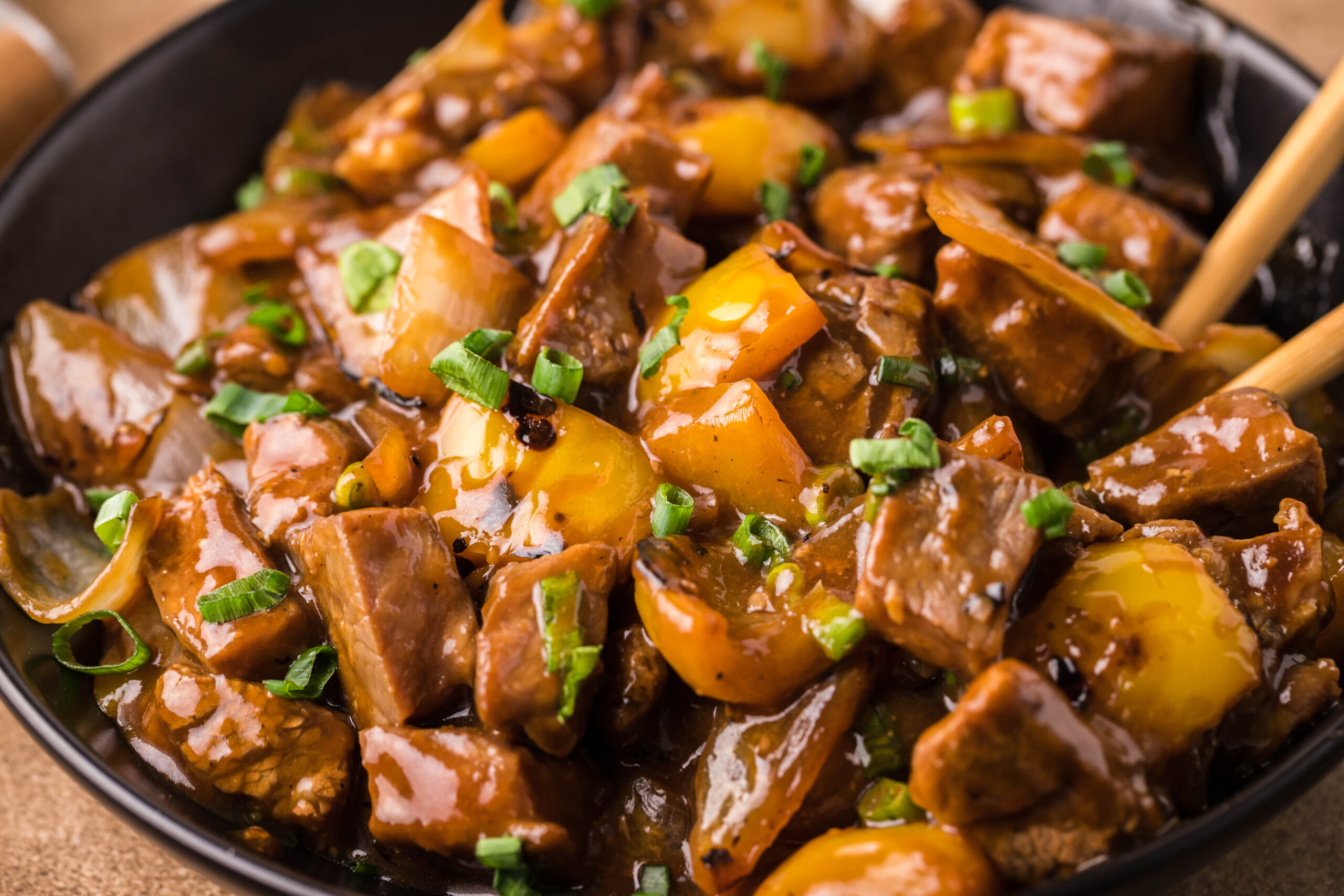 Close up view of Teriyaki Steak Bites in a black dish 