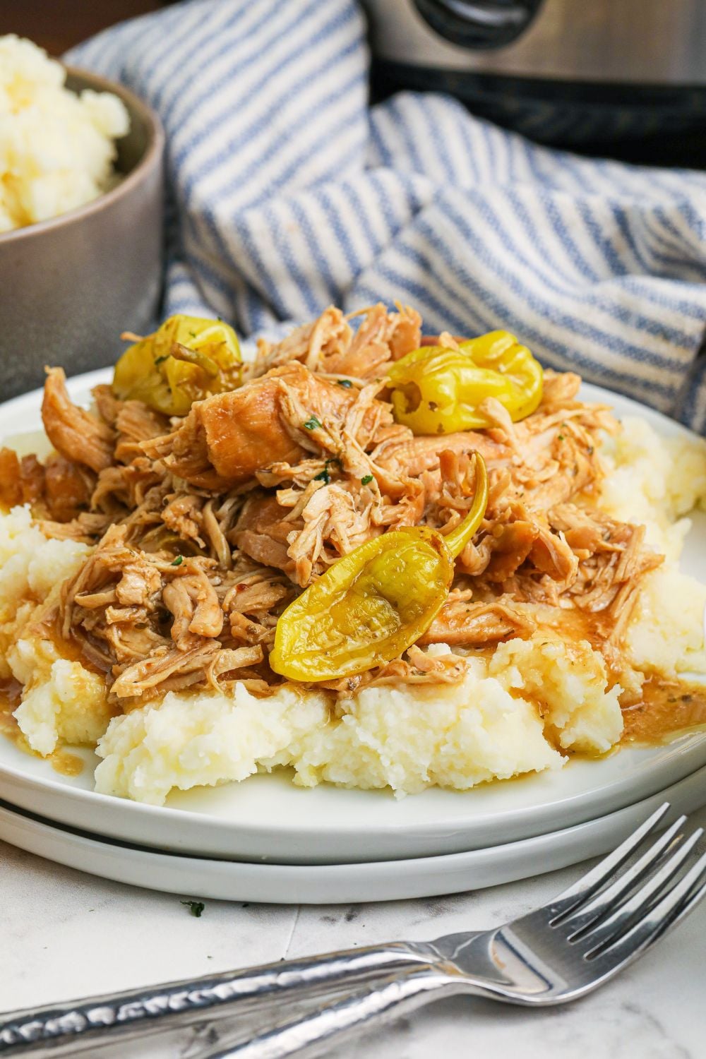 mississippi chicken on plate with forks in front