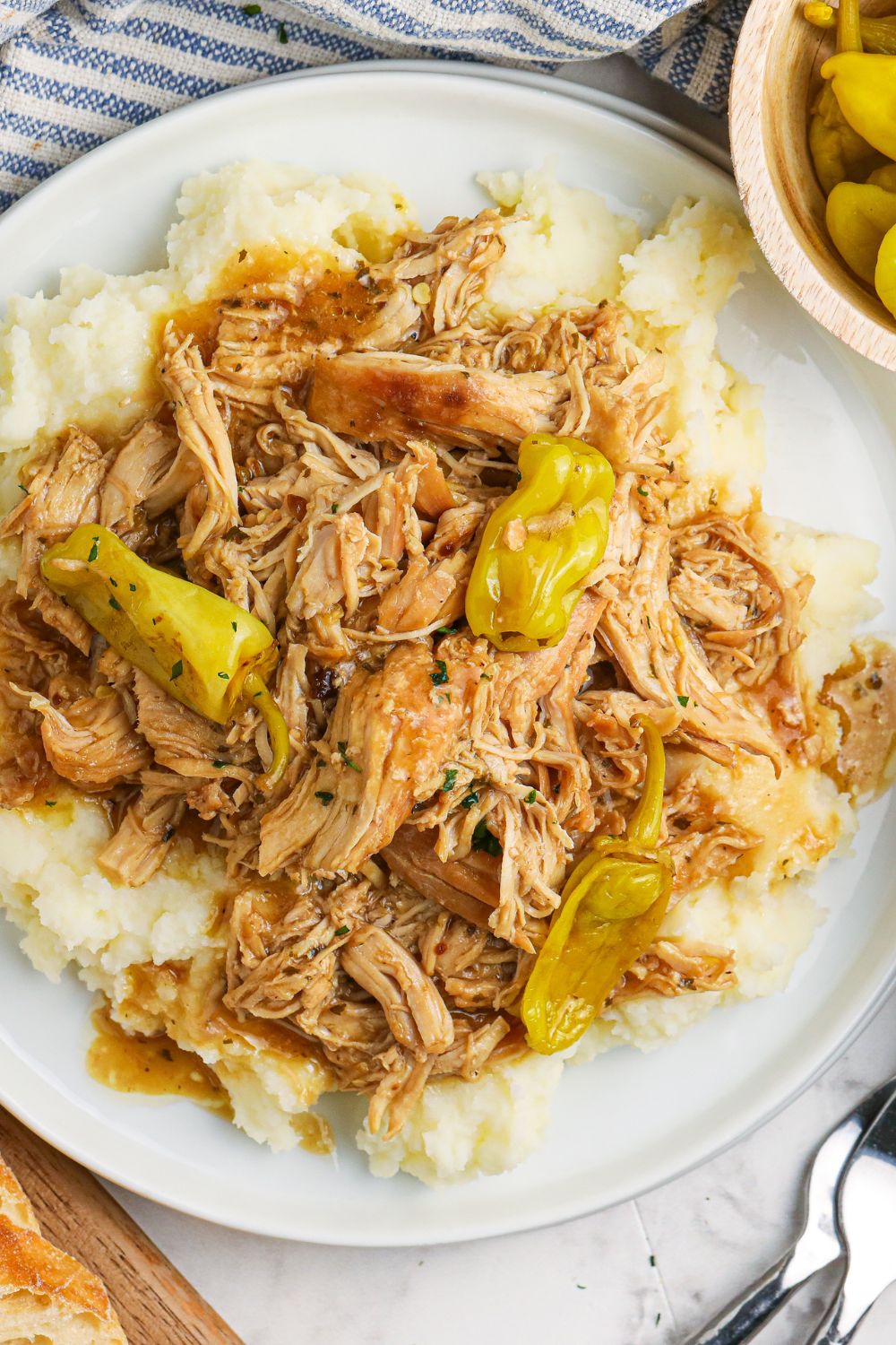 chicken shredded with pepperso n plate with mashed potatoes underneath