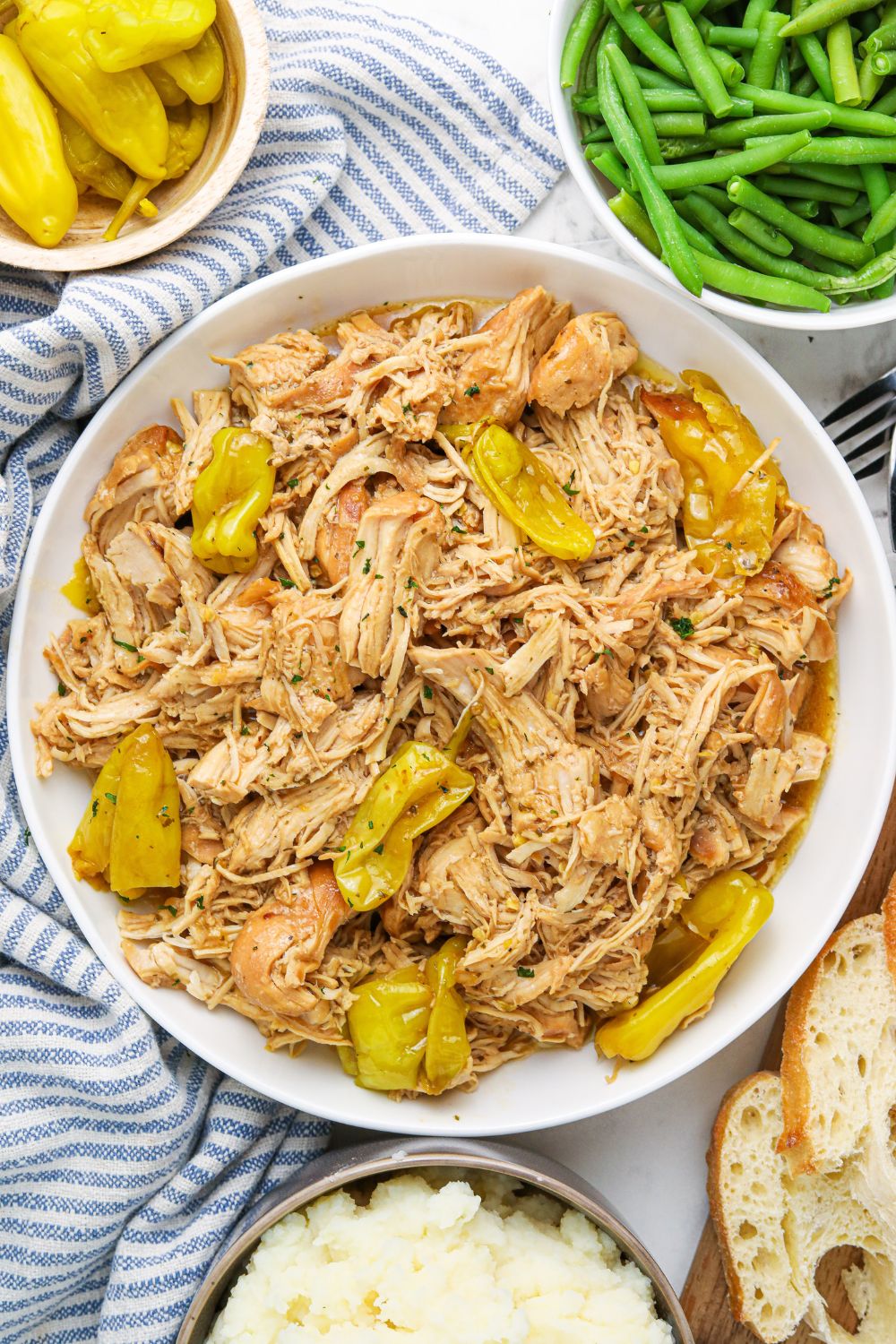 mississippi chicken and sides on table in bowls