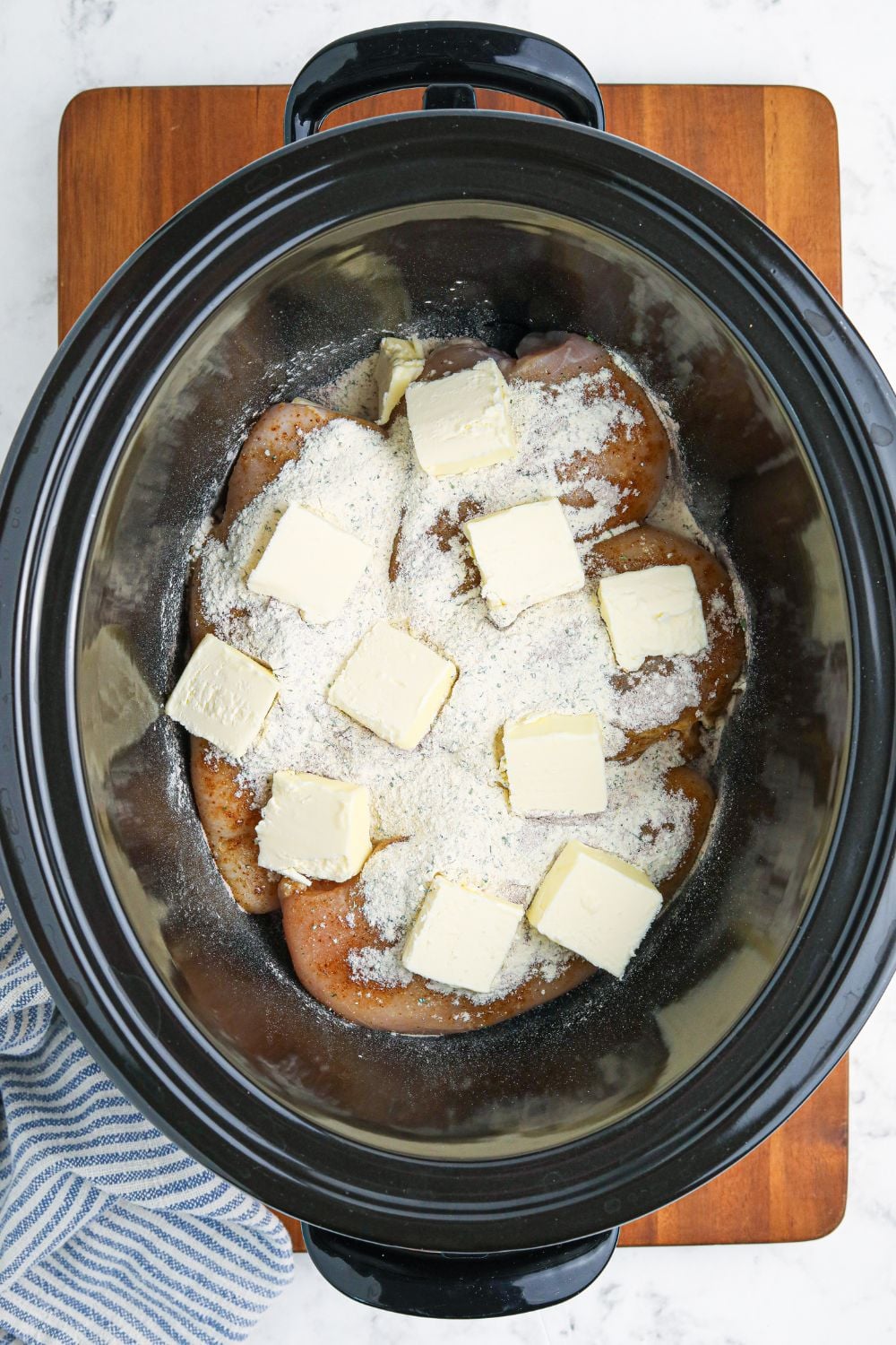 seasoning and butter on top of chicken