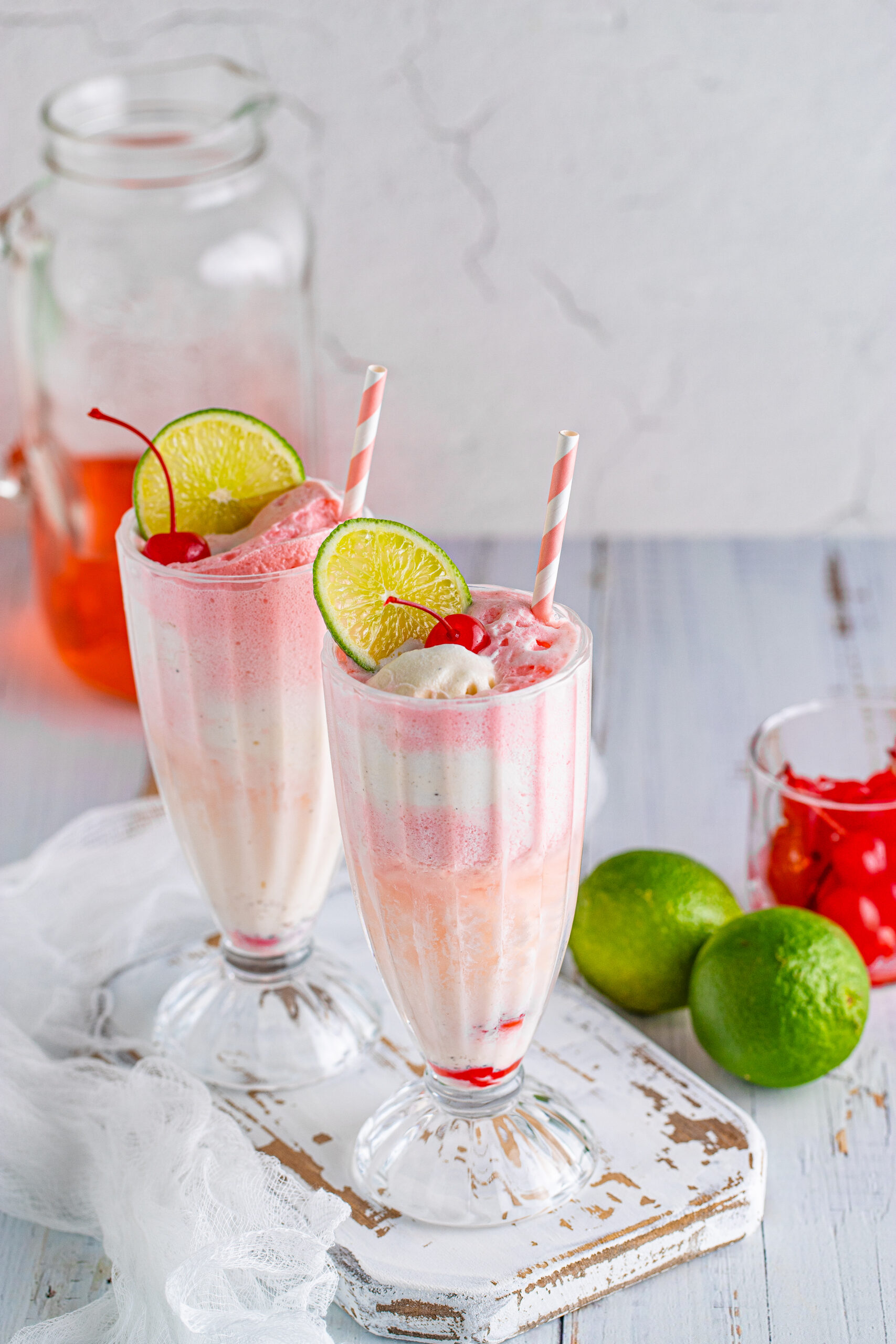 Front view of Dirty Shirley Float in a clear glass topped with a lime slice and cherry.