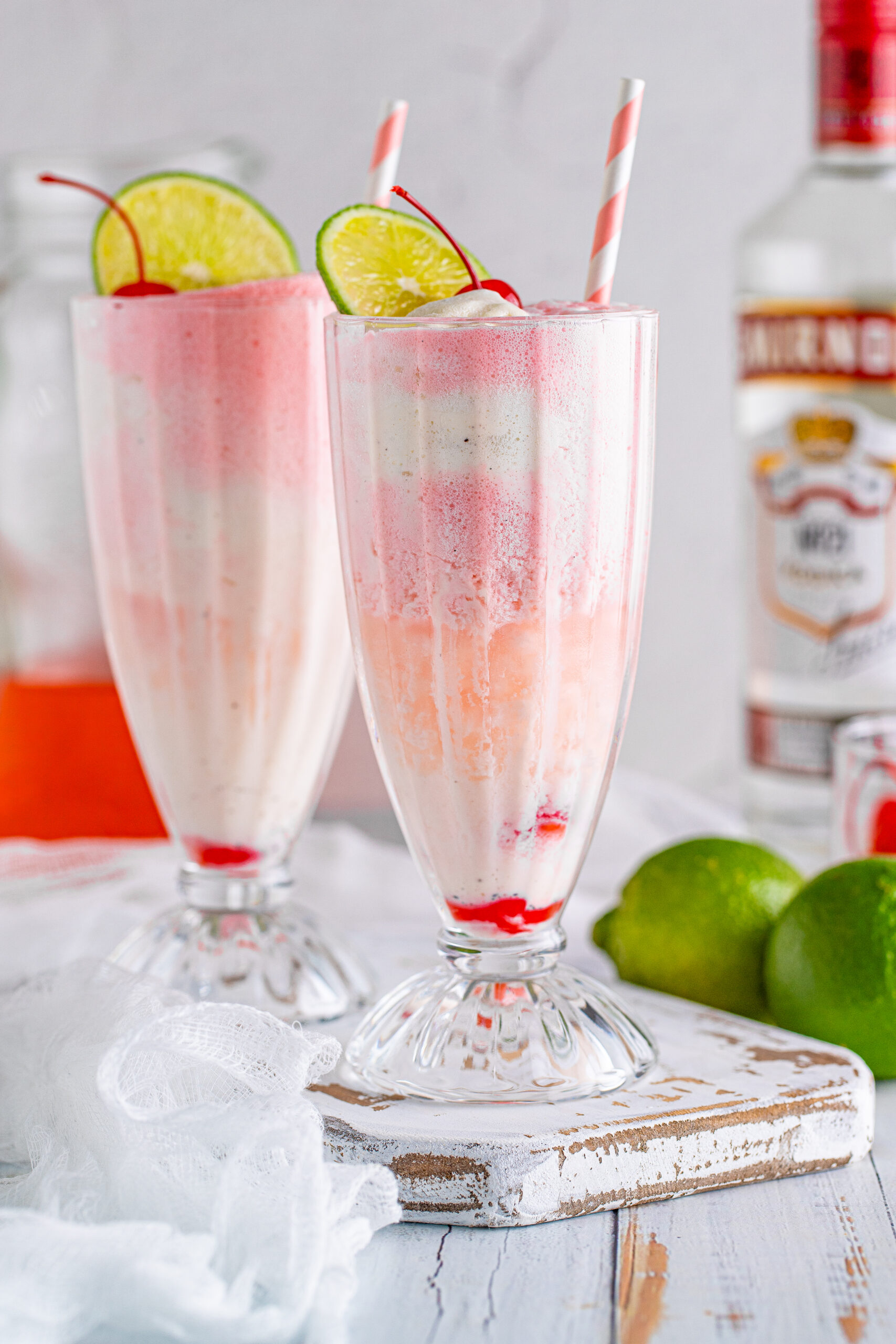 Front view of Dirty Shirley Float in a clear glass topped with a lime slice and cherry.