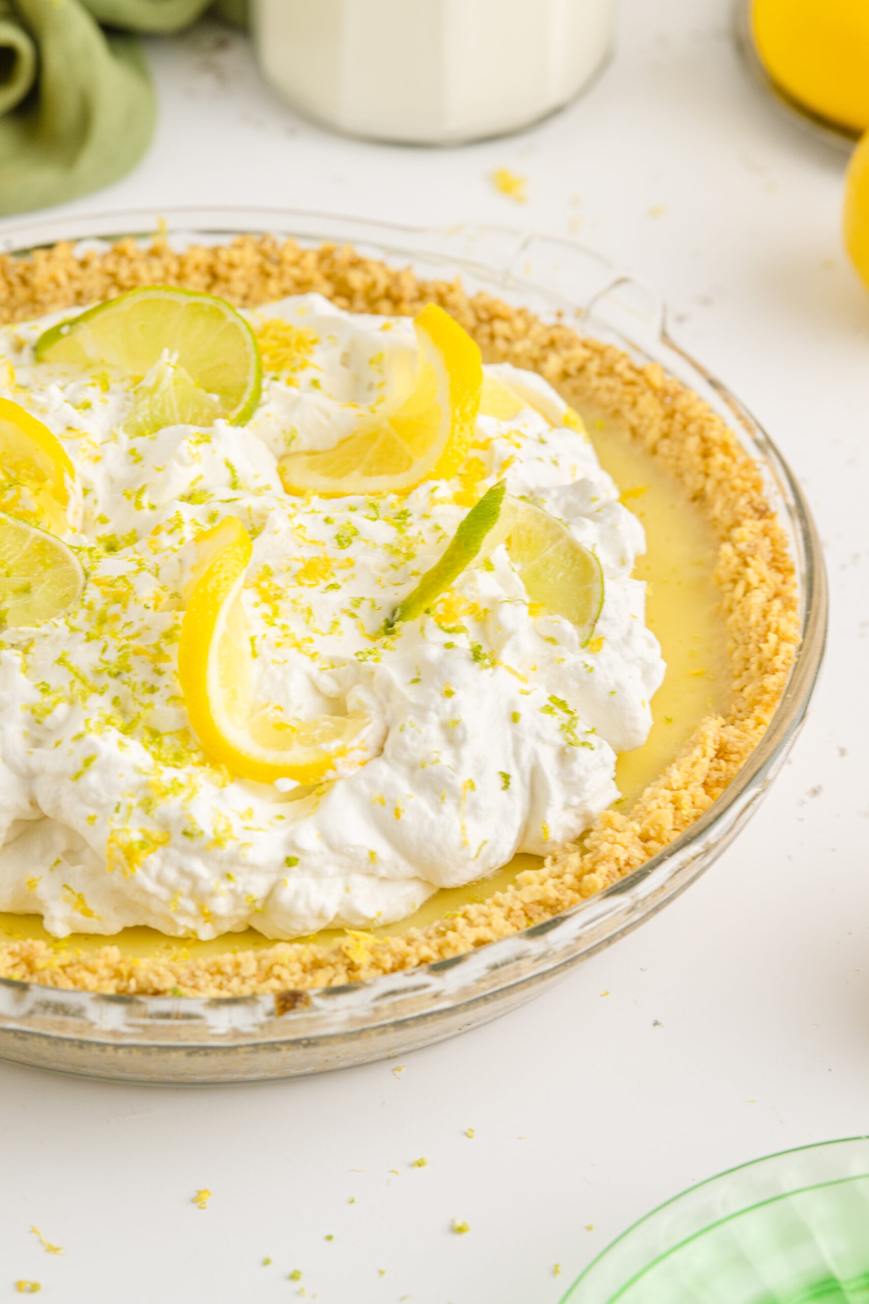 Side view of Atlantic Beach Pie topped with fresh lemons and limes.