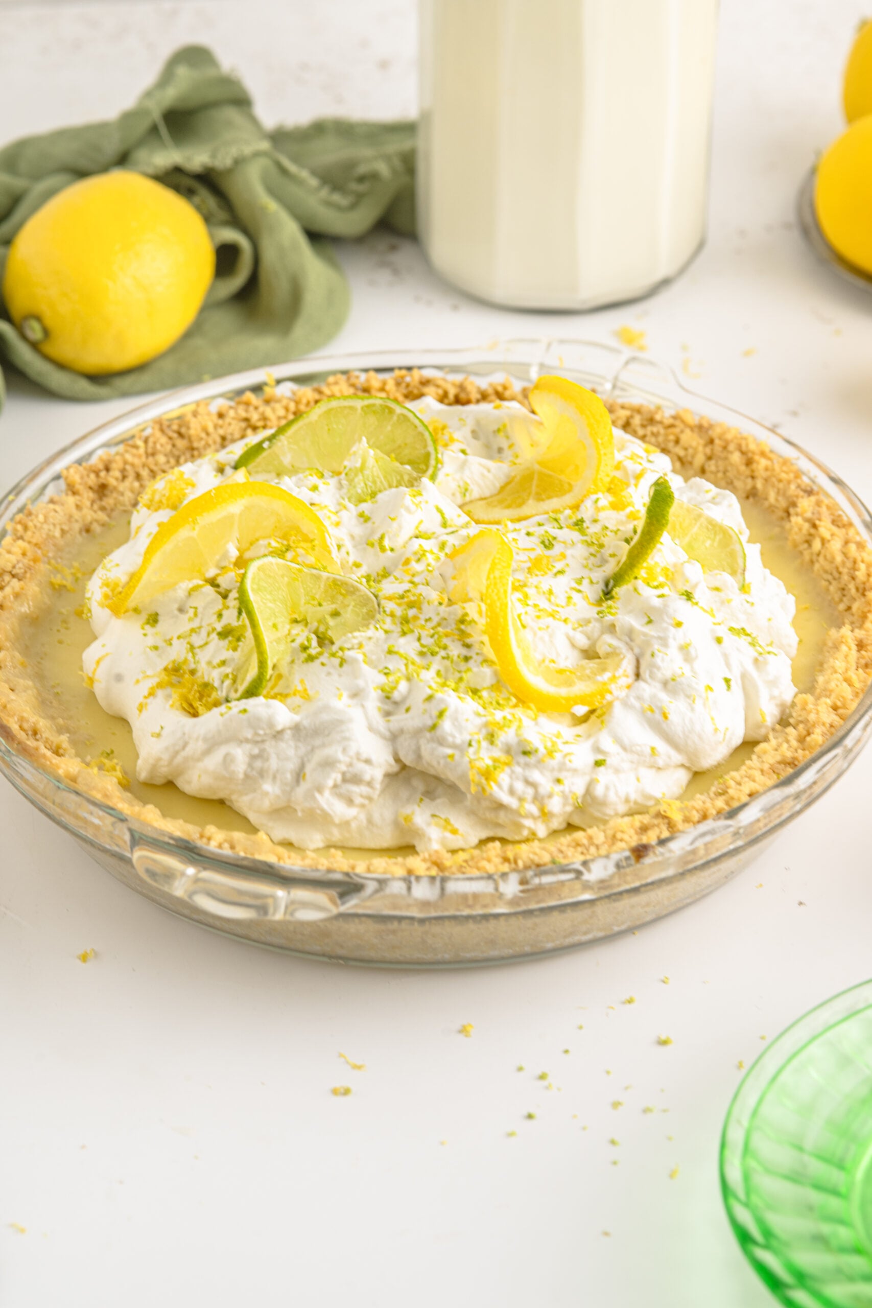 Side view of Atlantic Beach Pie topped with fresh lemons and limes.