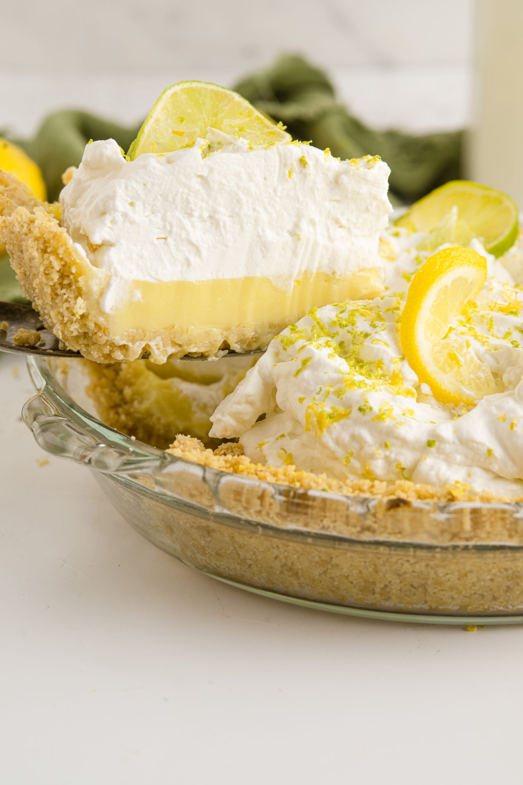 A piece of Atlantic Beach Pie being removed from the baking dish with a silver spatula.