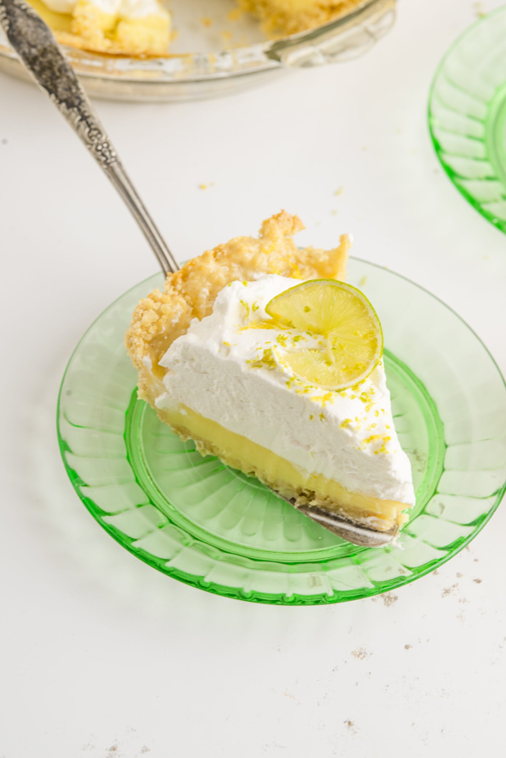 A piece of Atlantic Beach Pie being placed on a green plate.