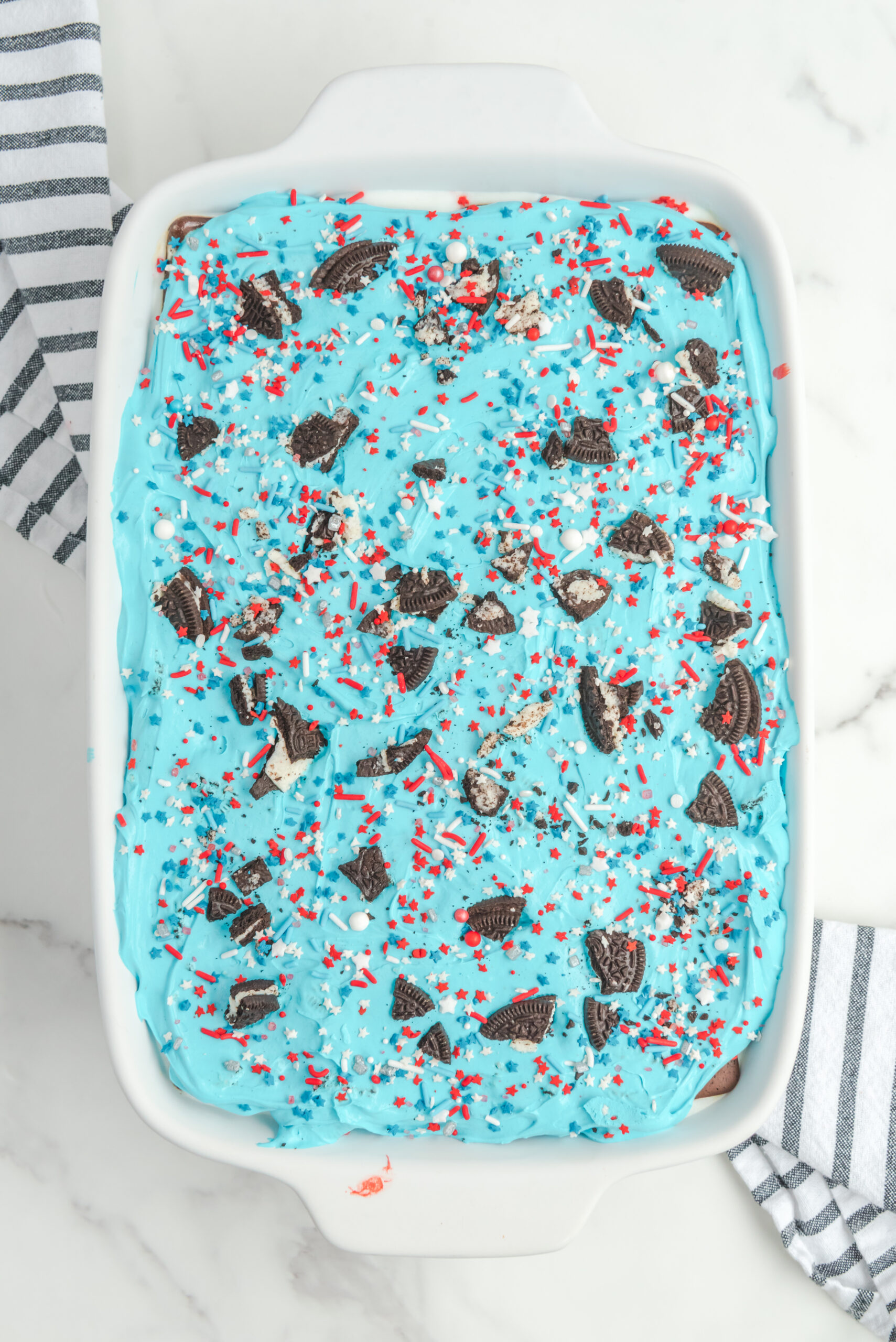 Overhead view of Patriotic Ice Cream Sandwich Cake in a white baking dish.