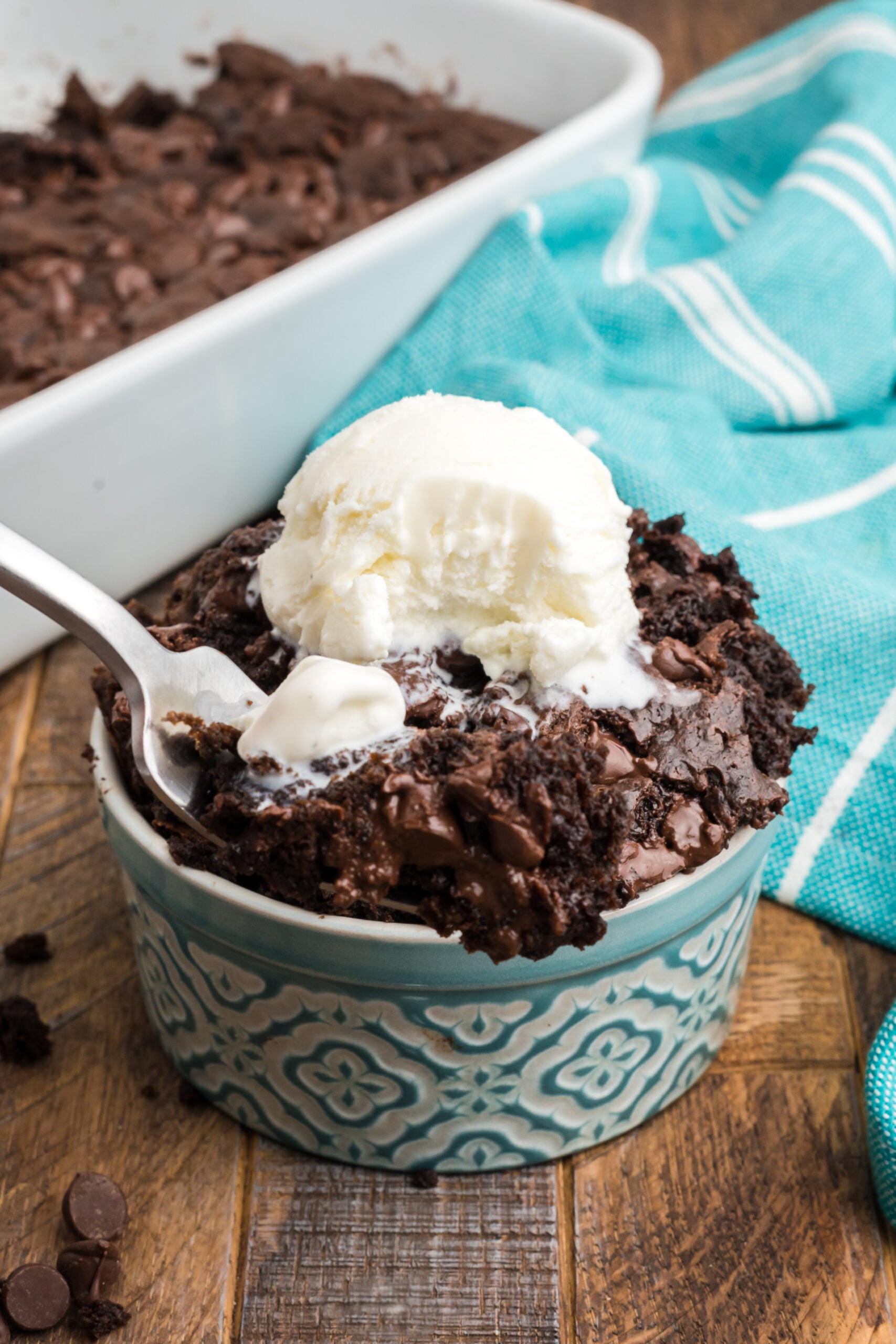 Front view of a silver fork removing a bite of Chocolate Dump Cake.