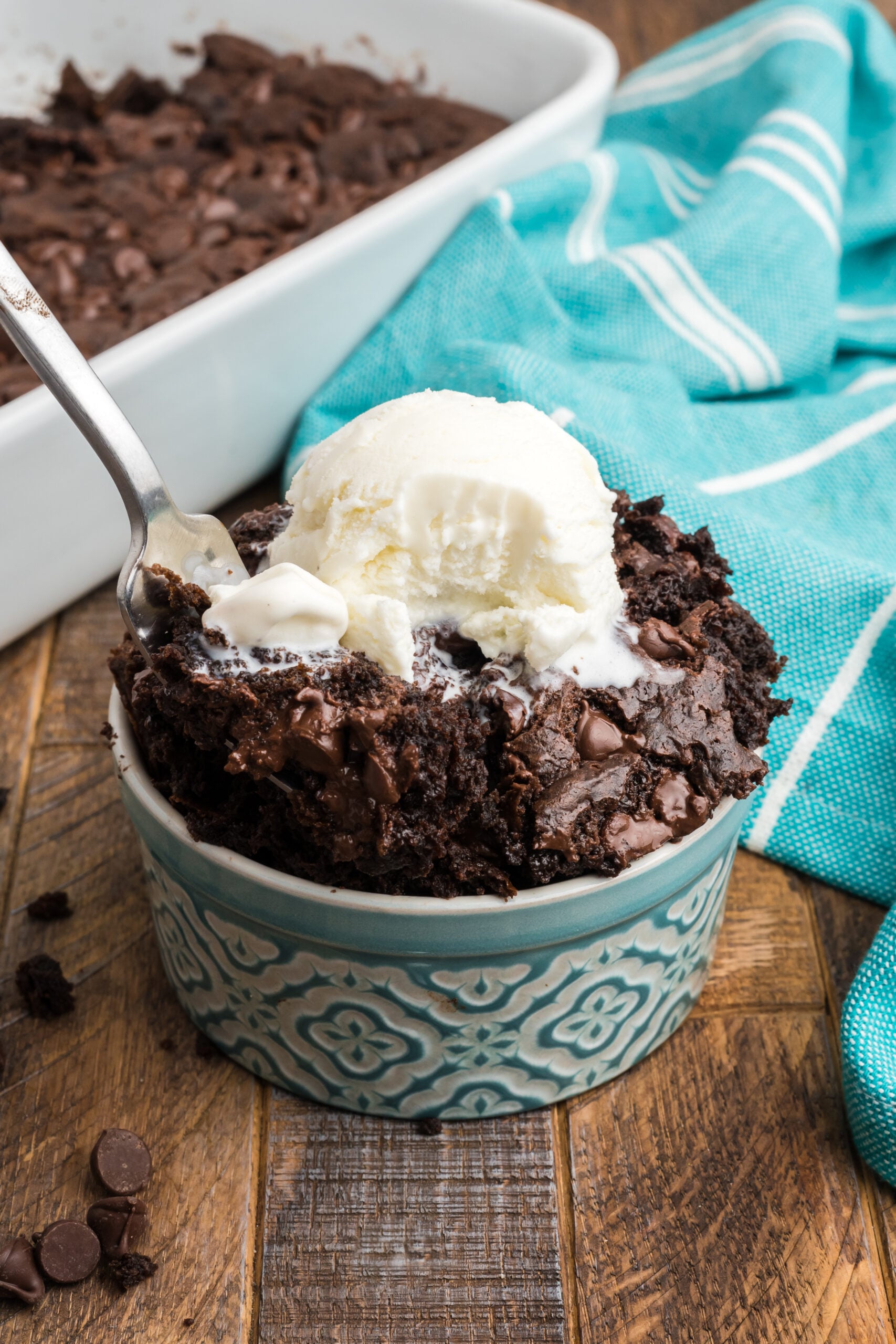 Front view of a silver fork removing a bite of Chocolate Dump Cake.