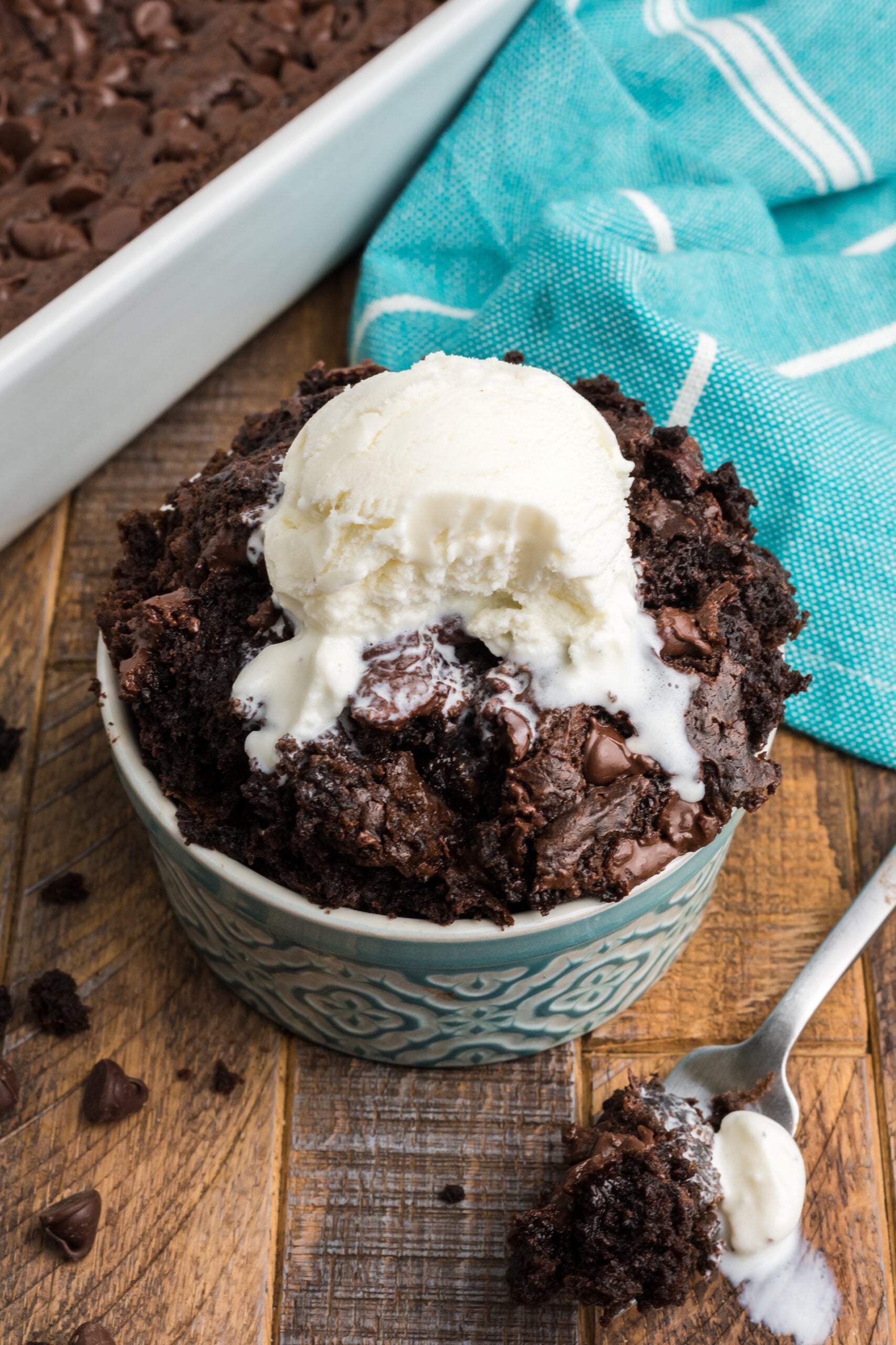 Front view of a serving of Chocolate Dump Cake with a bite removed by a silver fork.