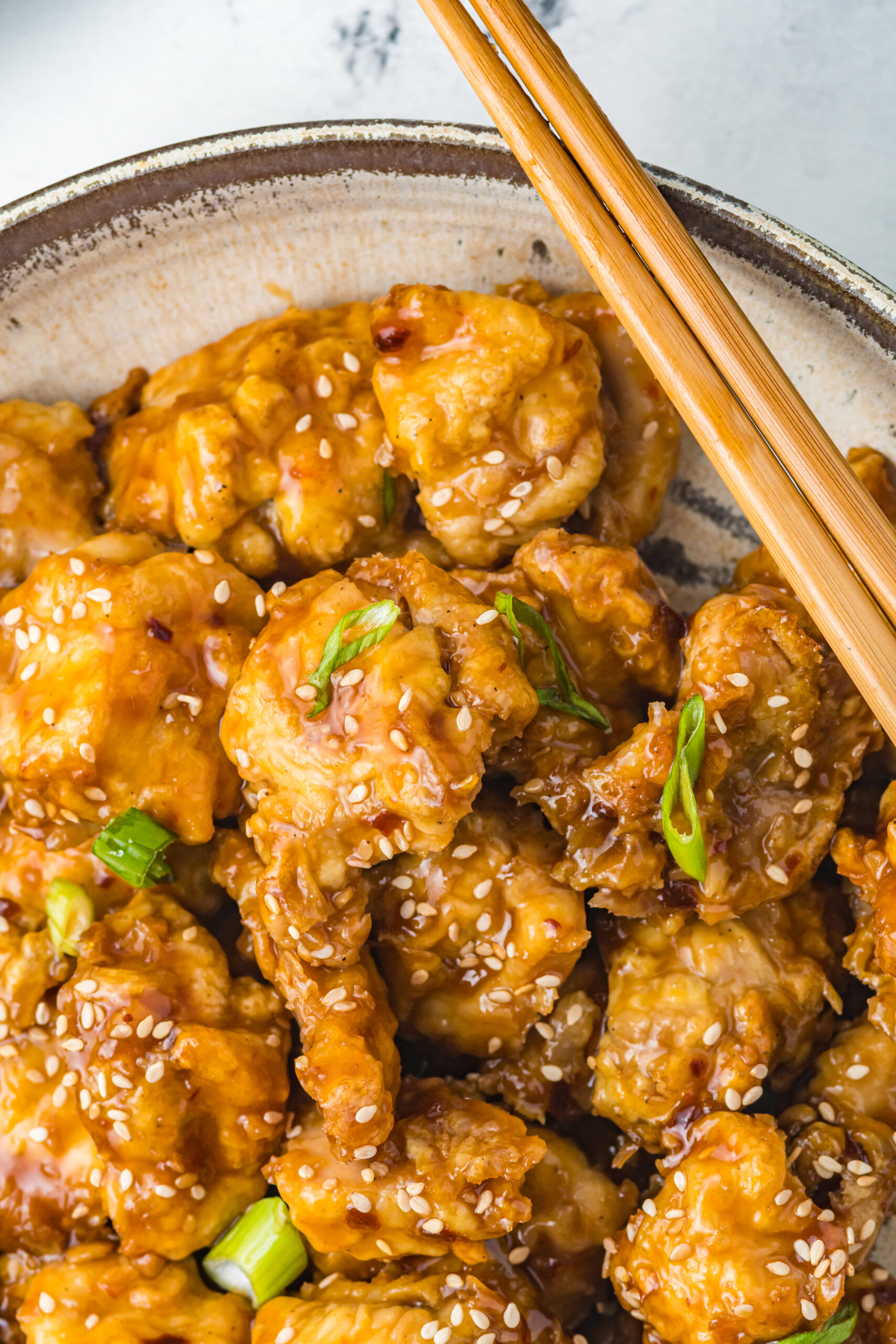 Close up view of Air Fryer General Tsos Chicken in a gray dish.