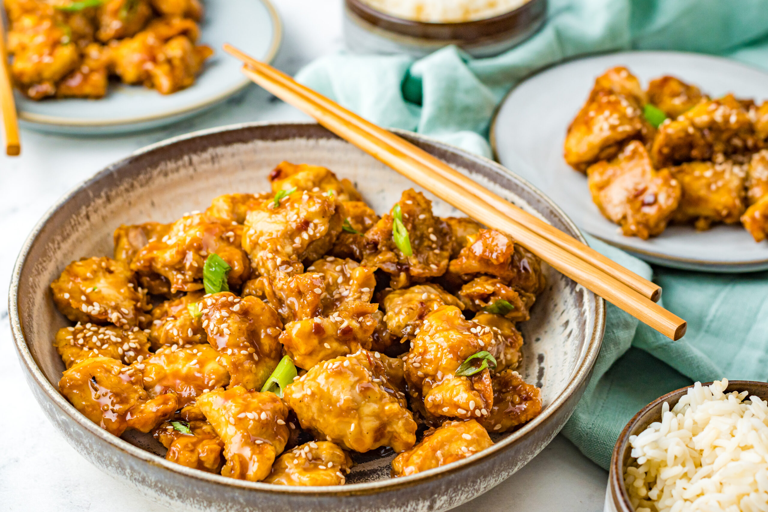 Front up view of Air Fryer General Tsos Chicken in a gray dish.