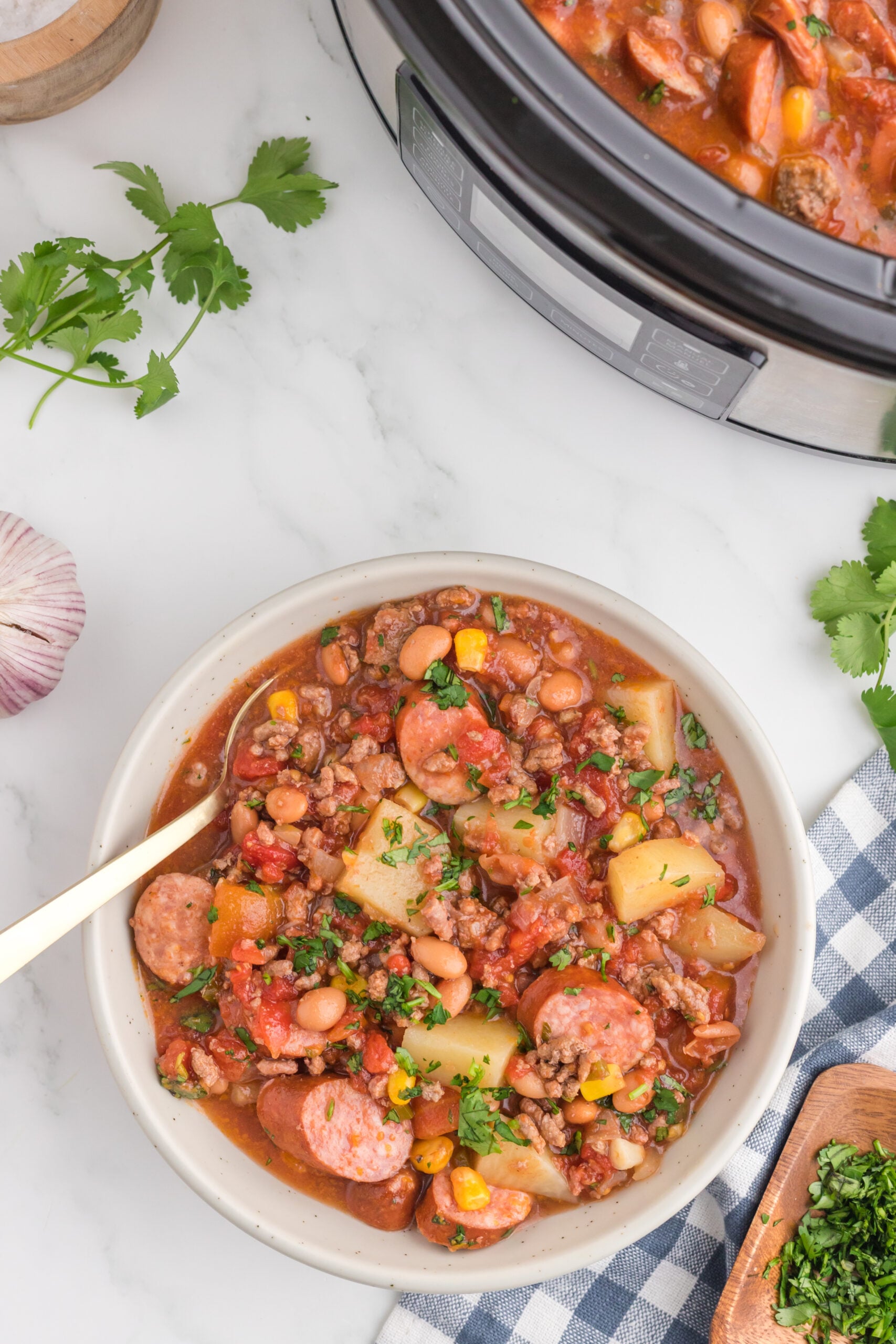 Overhead view of a serving of Slow Cooker Texas Cowboy Stew in a white bowl.