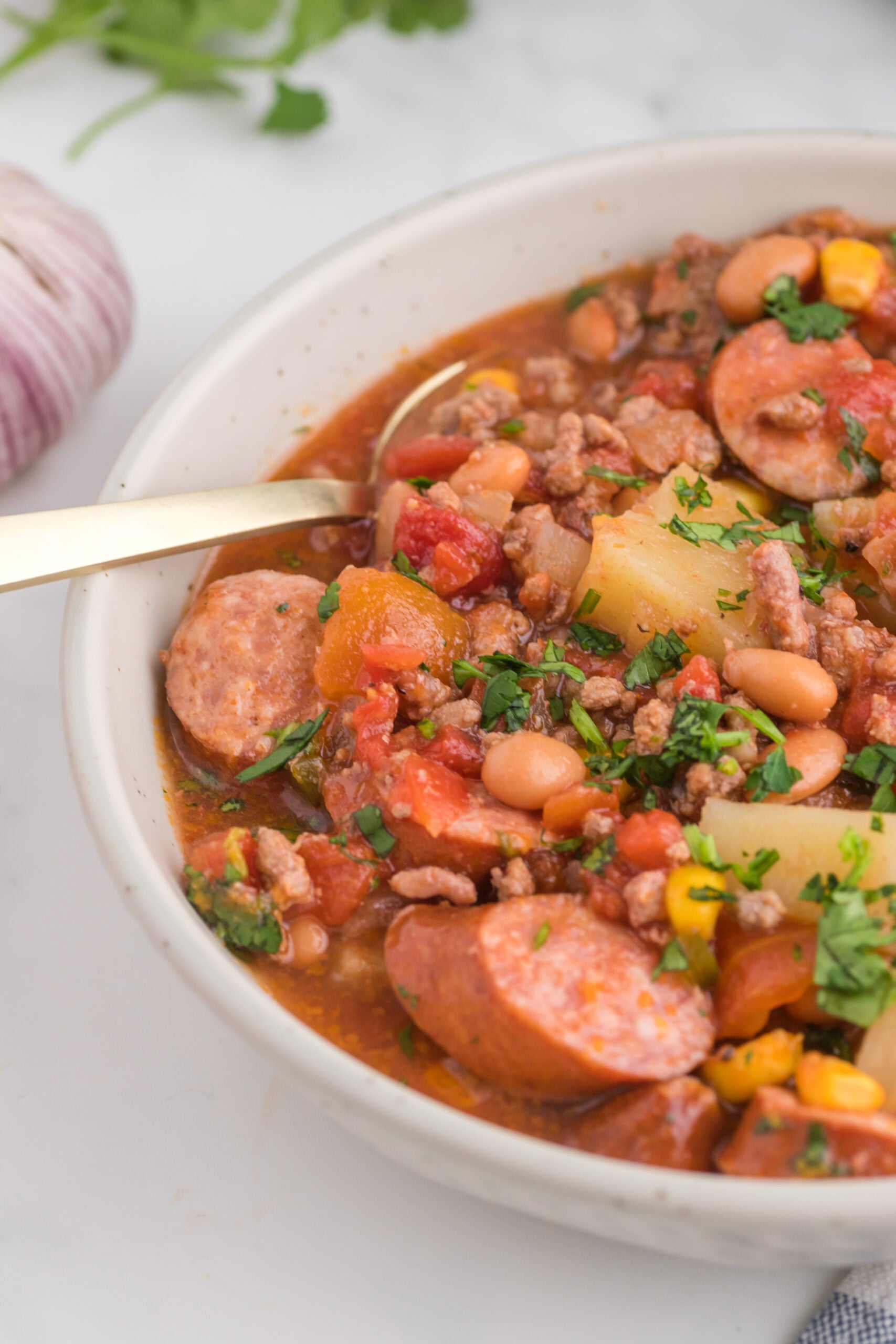Close up view of a serving of Slow Cooker Texas Cowboy Stew in a white bowl.