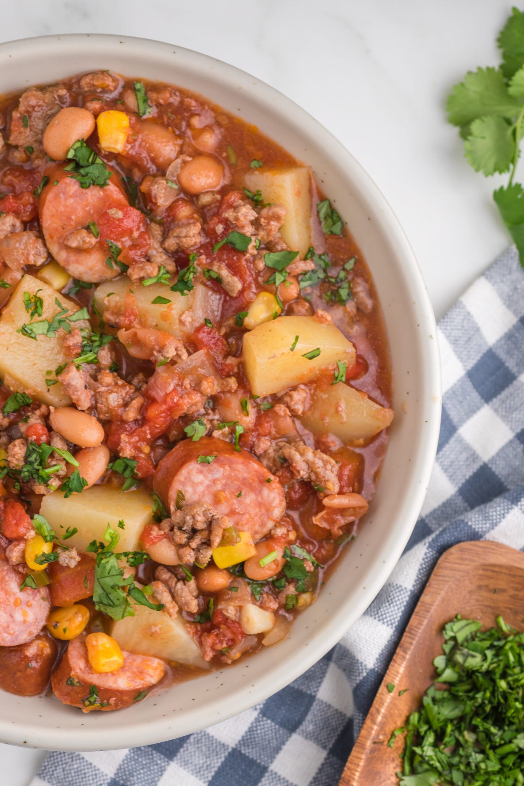 Overhead view of a serving of Slow Cooker Texas Cowboy Stew in a white bowl.