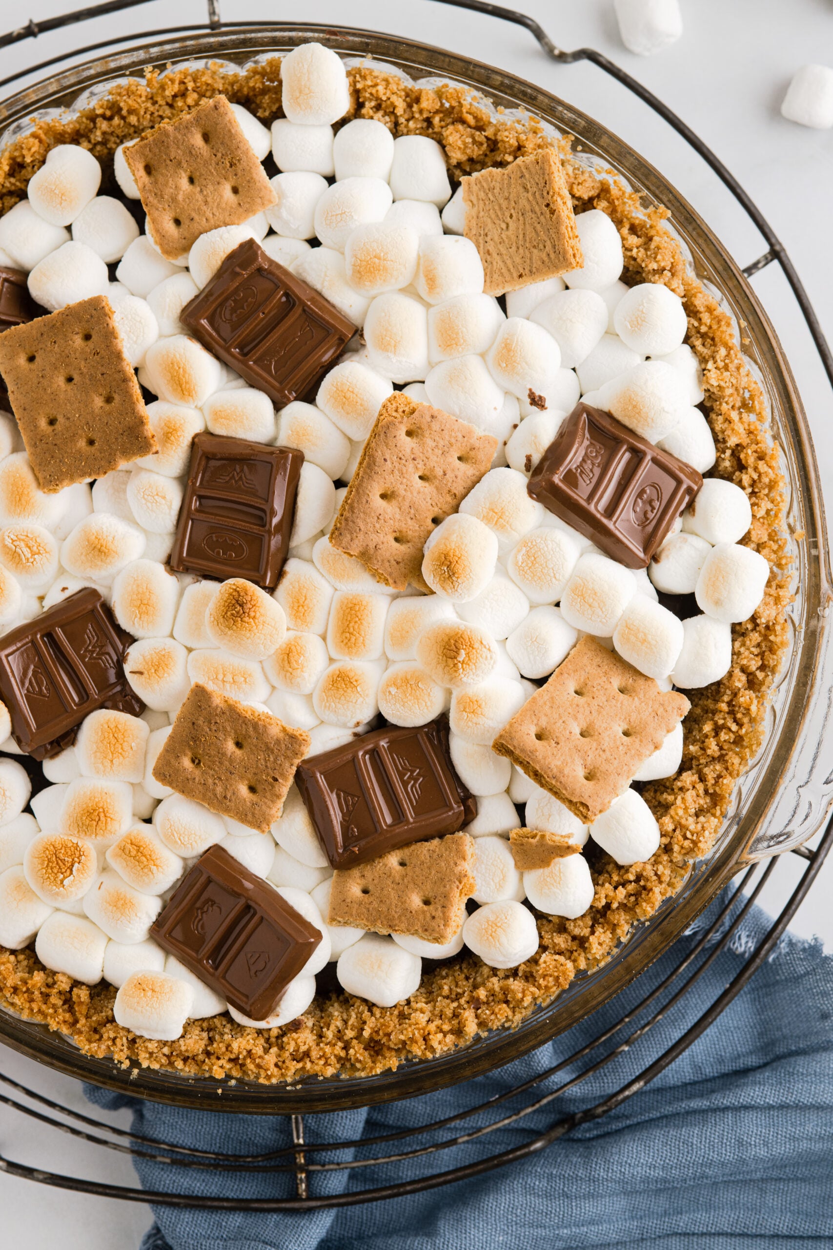 Close up overhead view of S'mores Pie on a wire rack. 