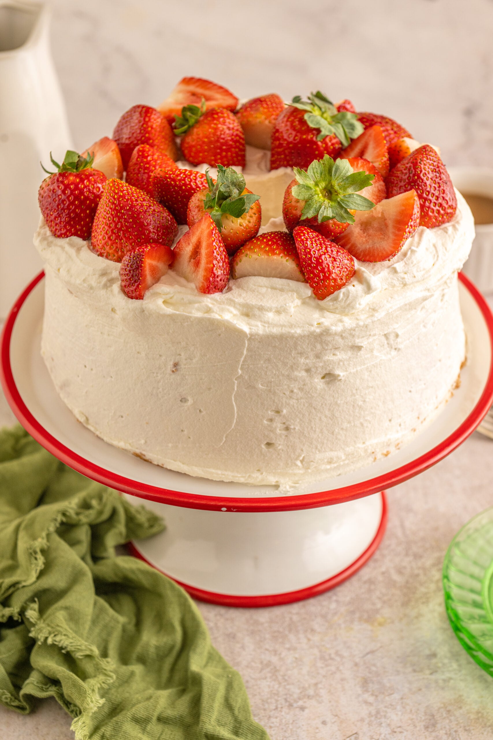 Side view of the Strawberry Angel Food Cake topped with fresh strawberries.