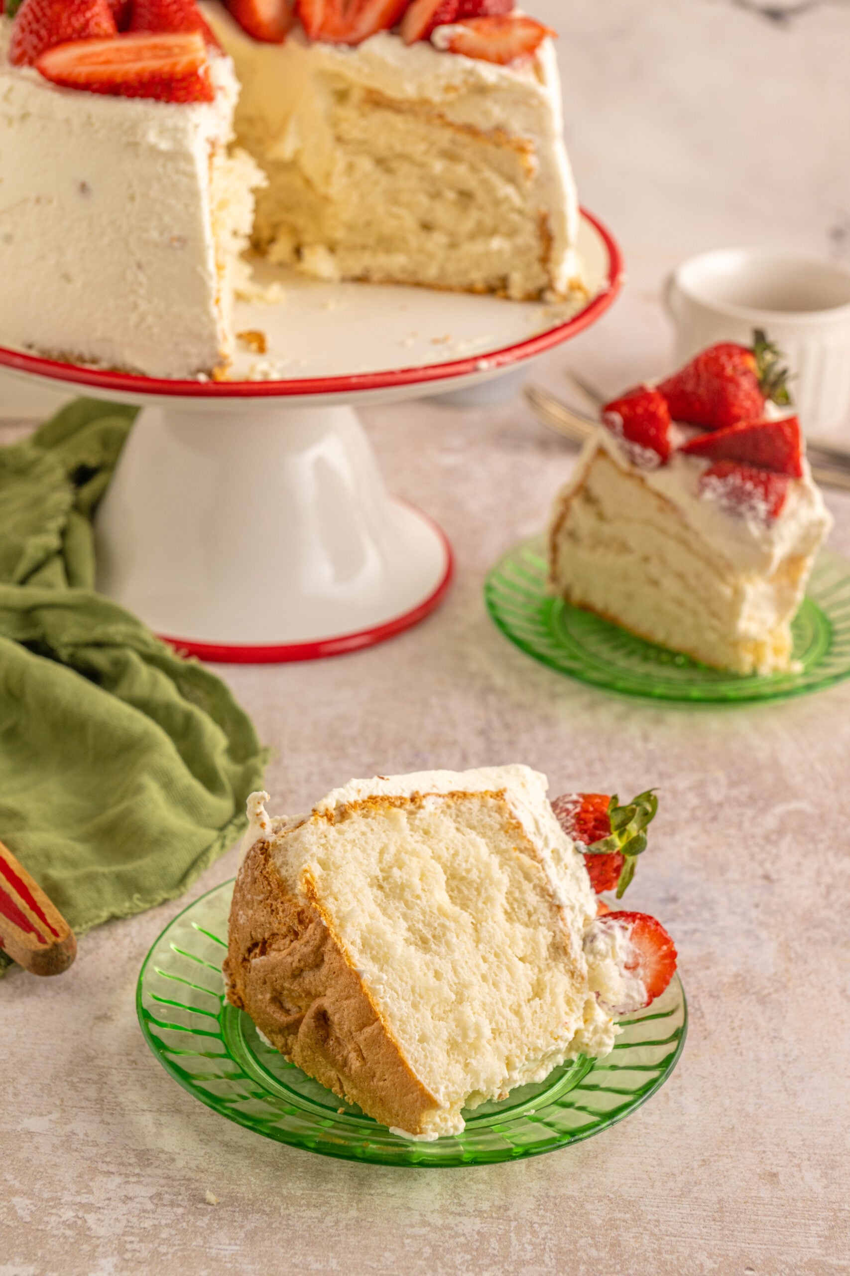 A piece of Strawberry Angel Food Cake on a green plate.