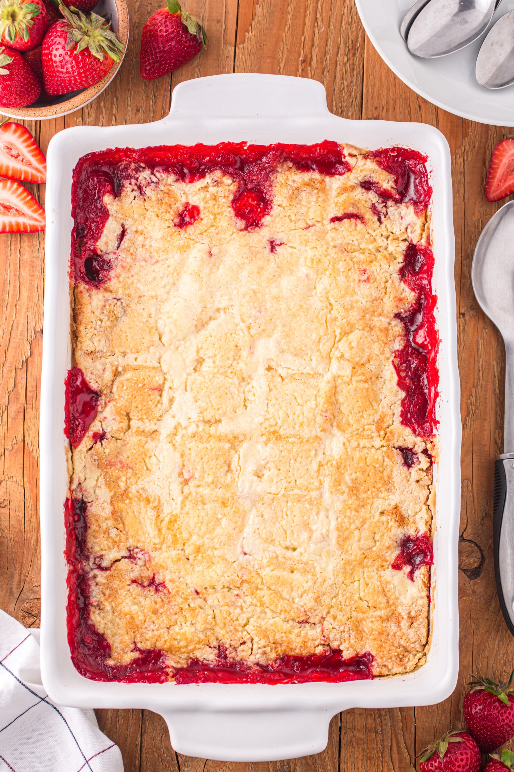 Overhead view of Strawberry Dump Cake in a white baking dish.