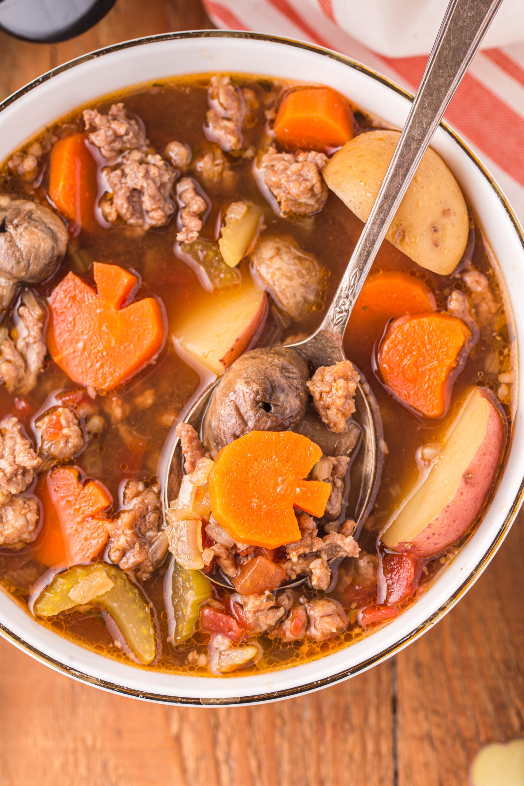 Overhead view of a silver spoon removing a bite of Witches Brew Stew.