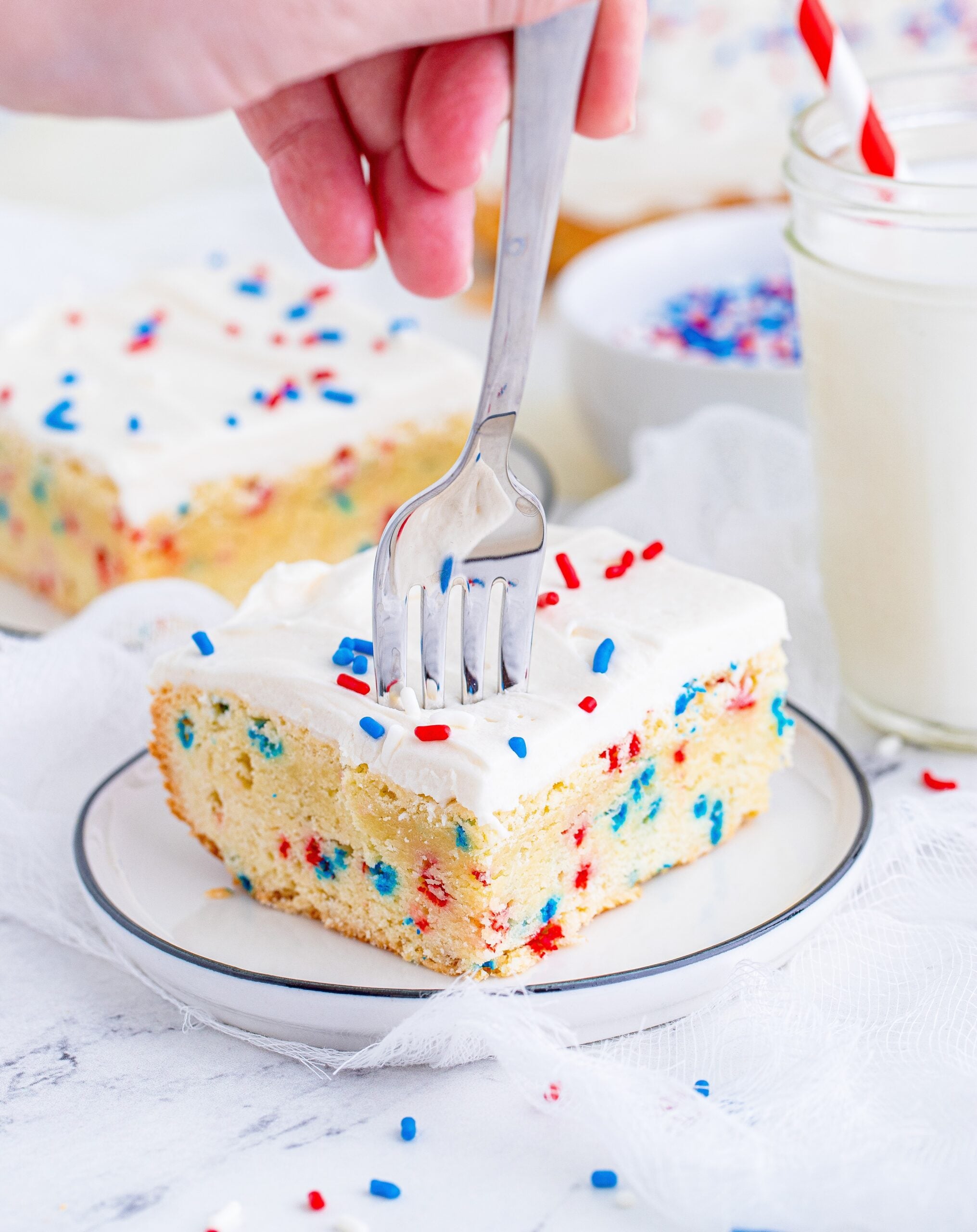 Front view of a silver fork removing a bite from a Patriotic Sugar Cookie Bar.