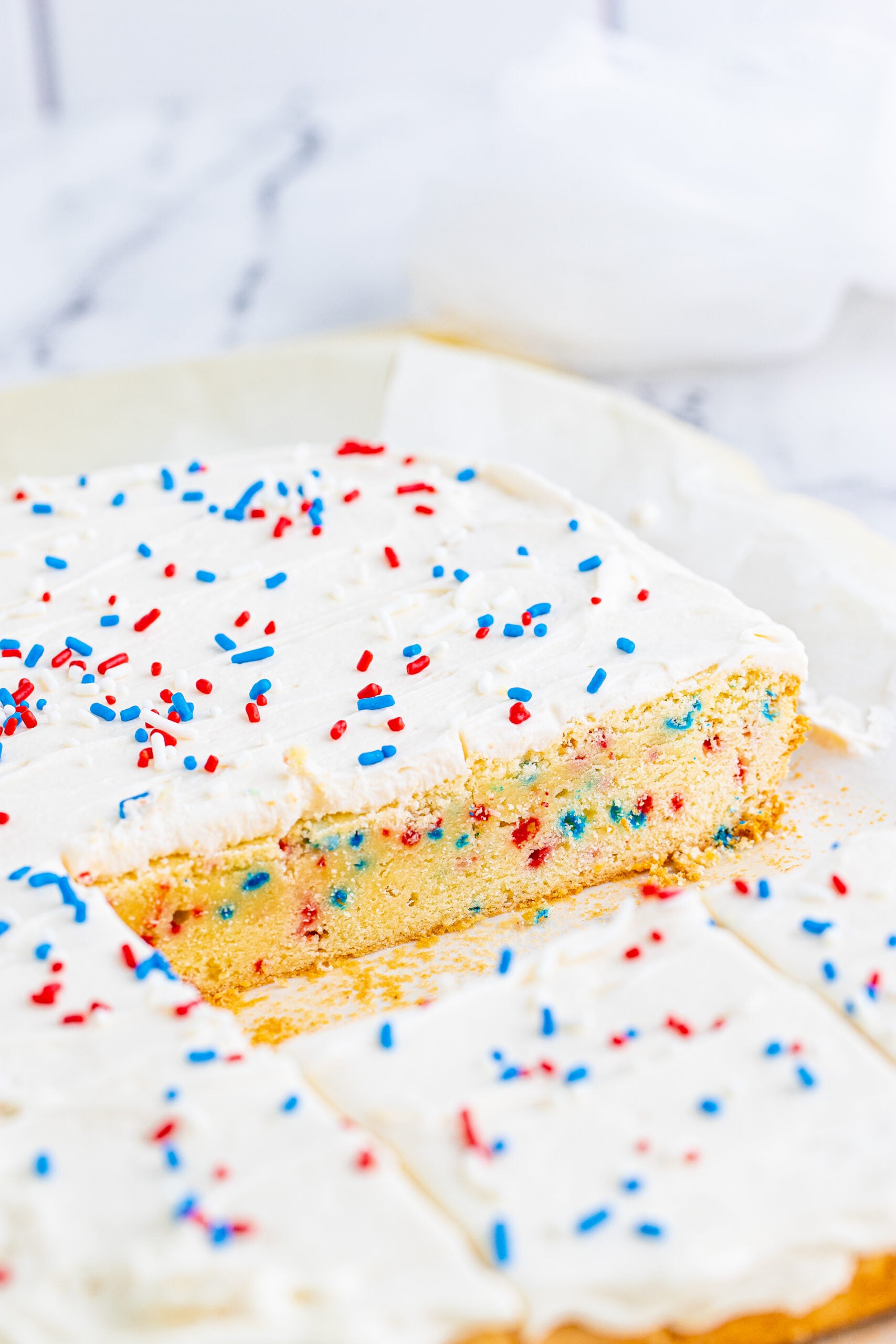 Close up view of Patriotic Sugar Cookie Bars with two pieces removed.