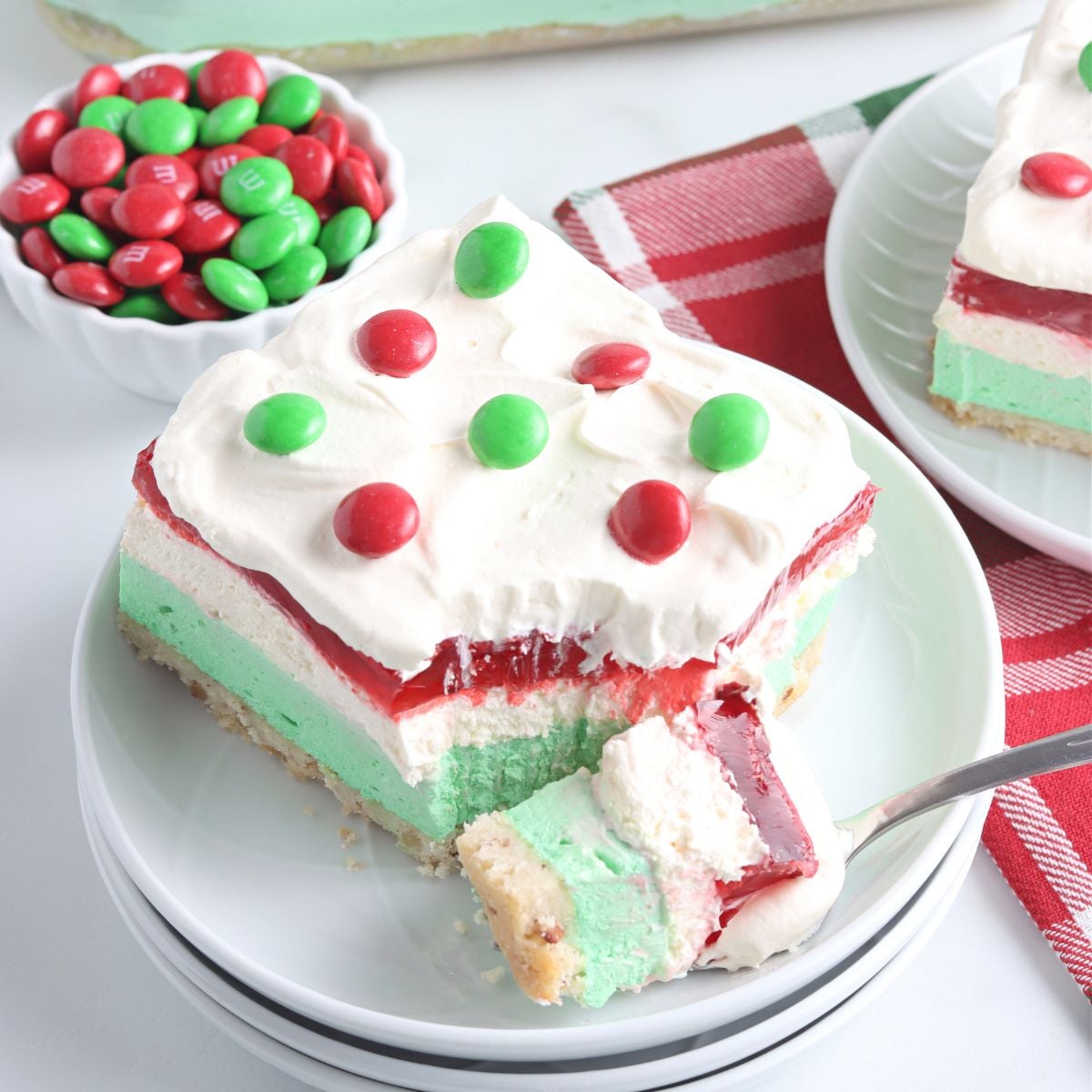 Christmas Lasagna sliced on plate with a bite full on fork