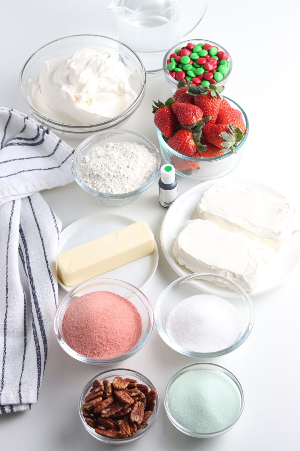 ingredients for a layered Christmas dessert on table in little bowls