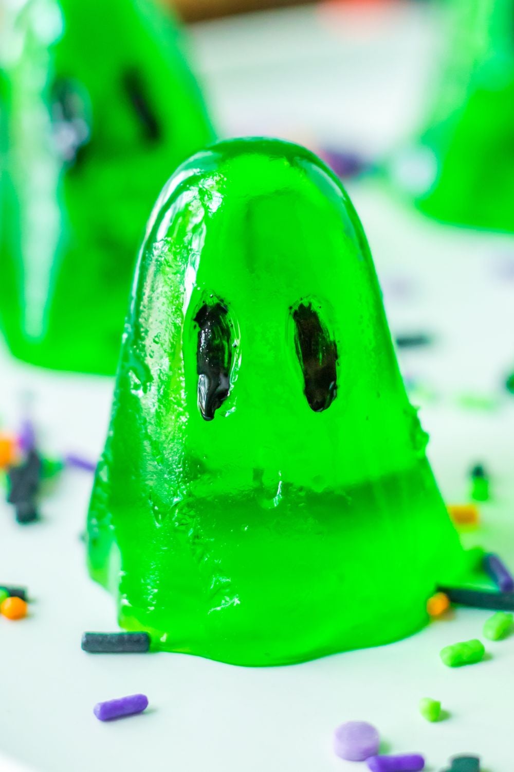 ghost shaped jello shots on table with sprinkles